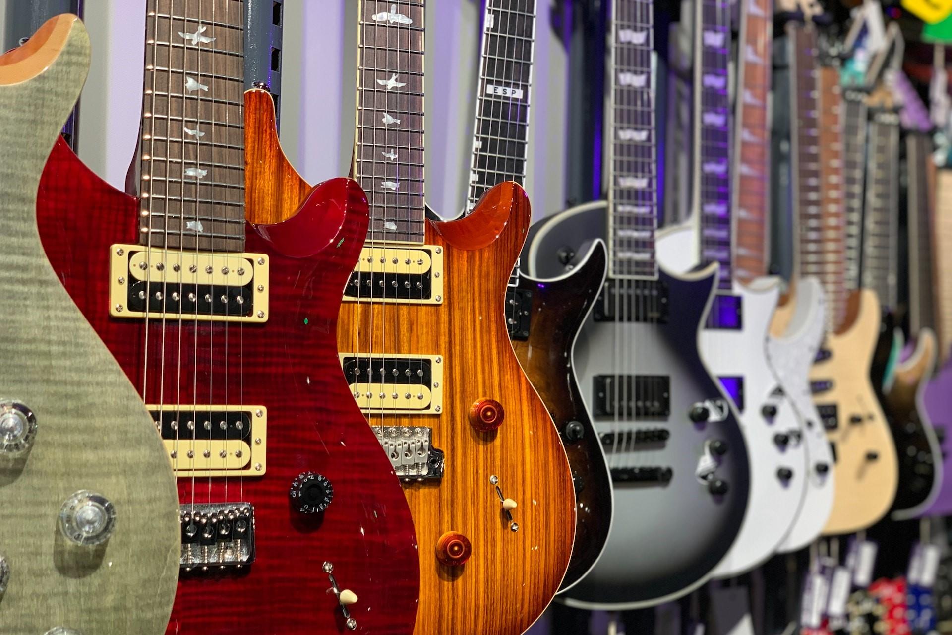 Cutaway electric guitars hanging in a music shop.