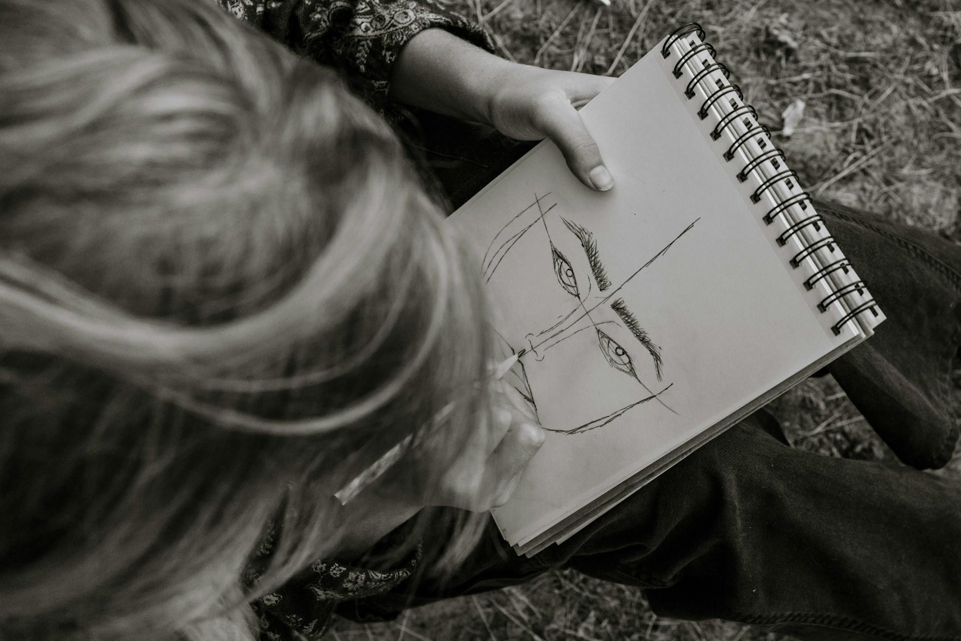 A person sketching a face.