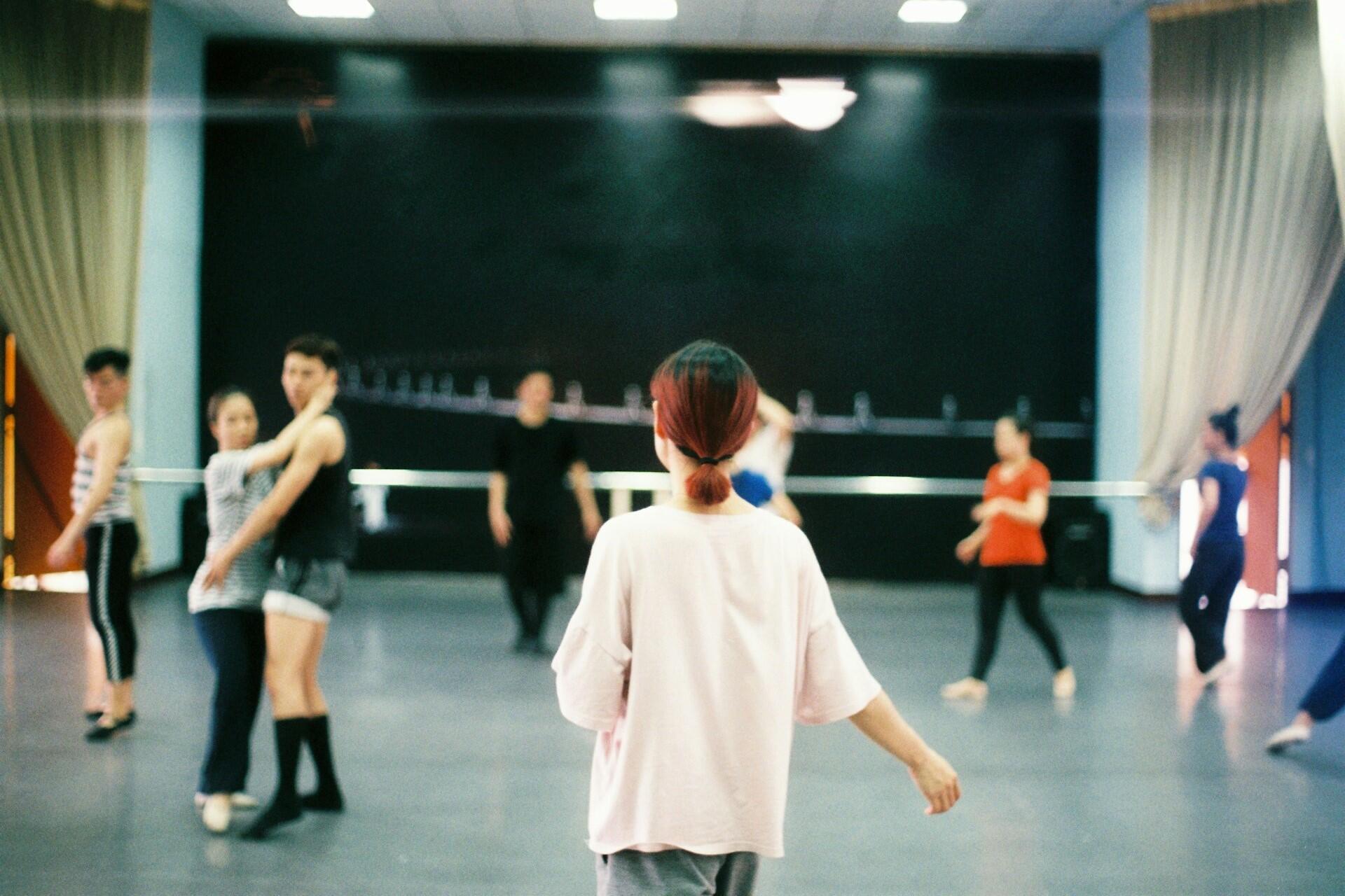 A girl entering a dance class.