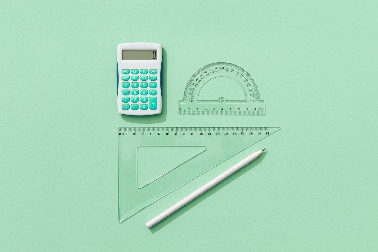 Supplies commonly used for geometry class against a light green background.
