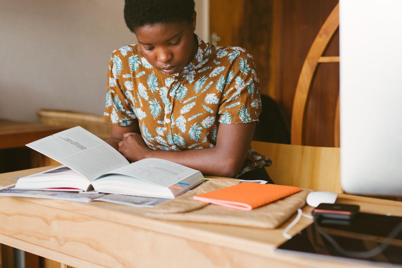 A student reads a textbook closely.