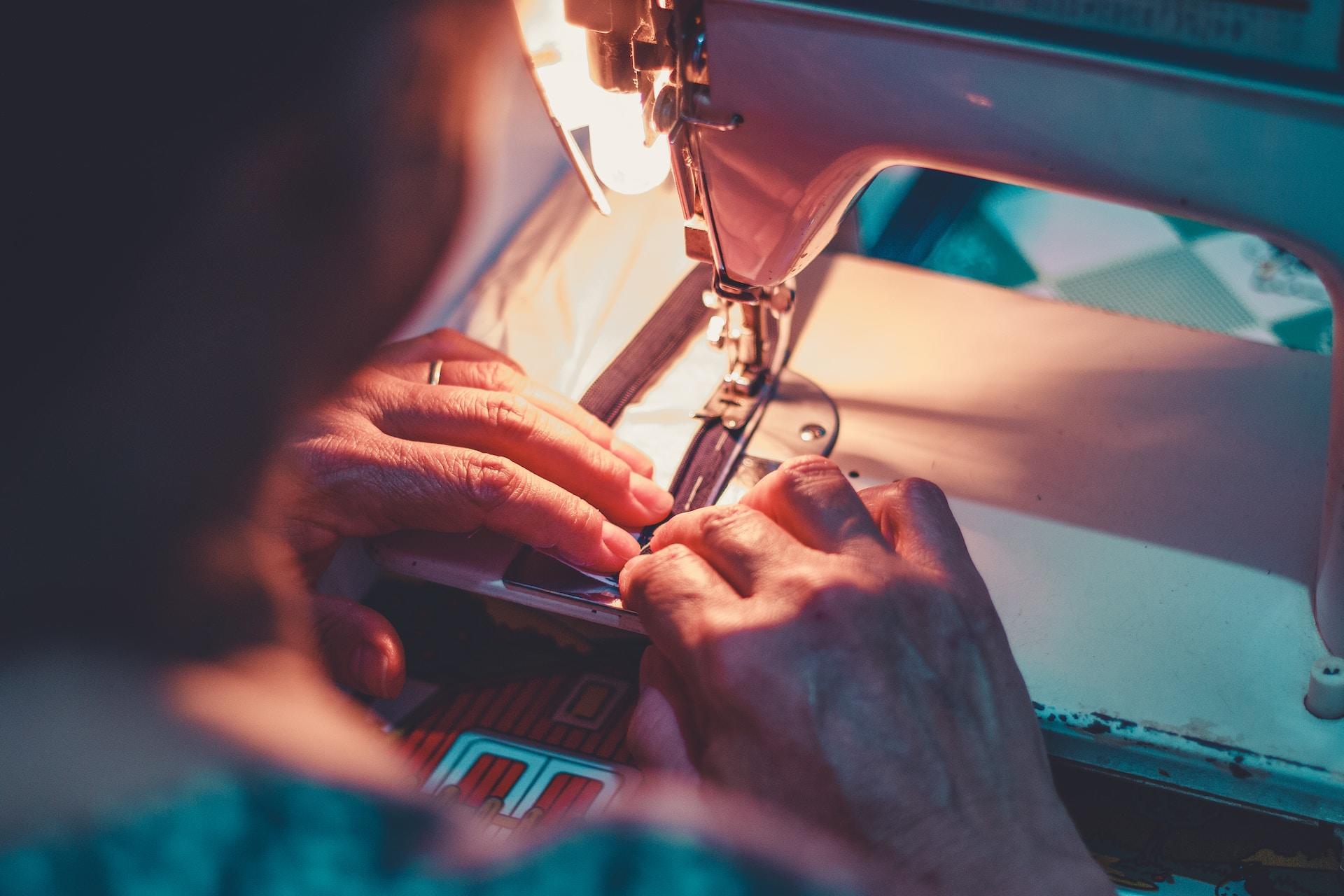 A person using a sewing machine.