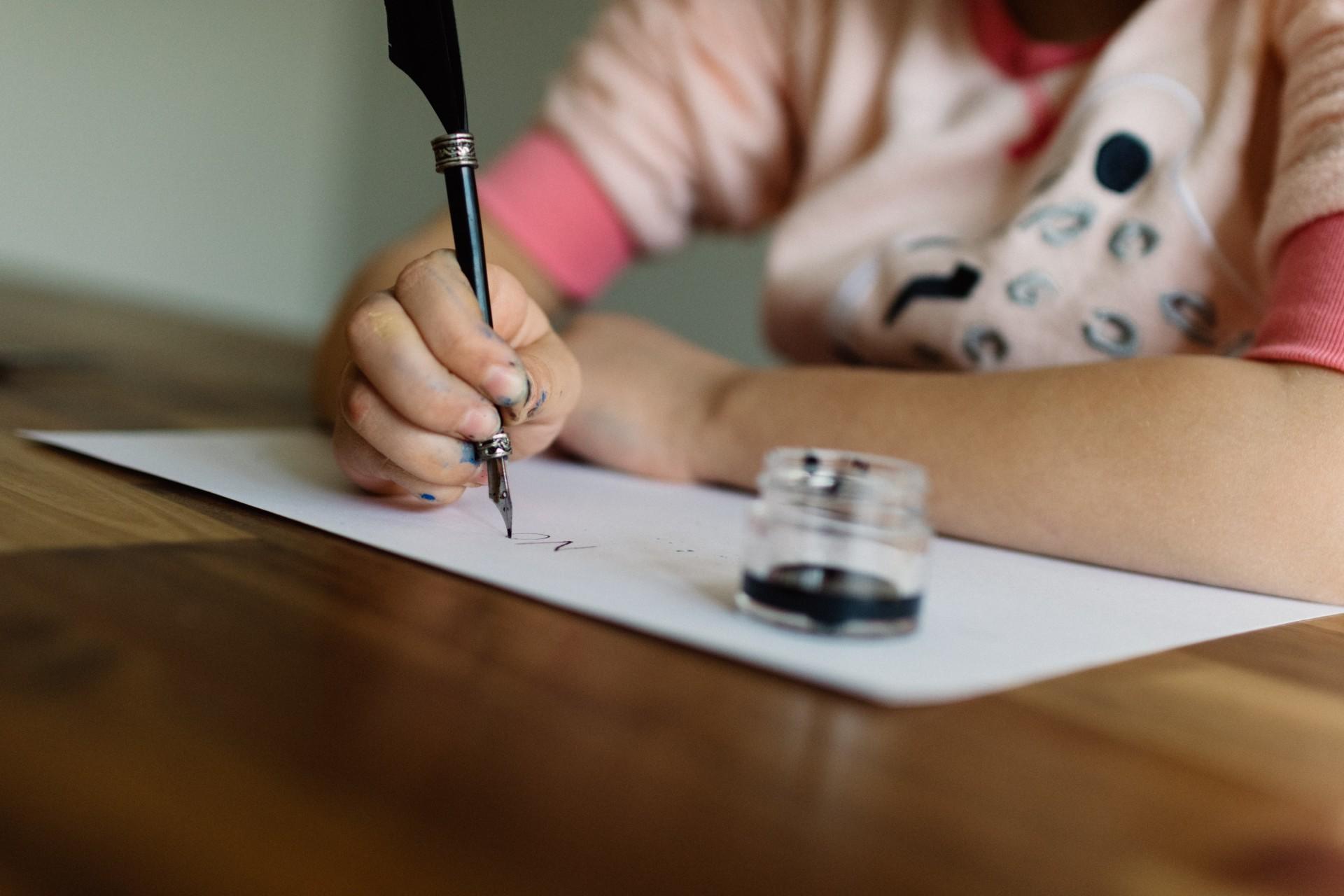 A person writing with a fountain pen