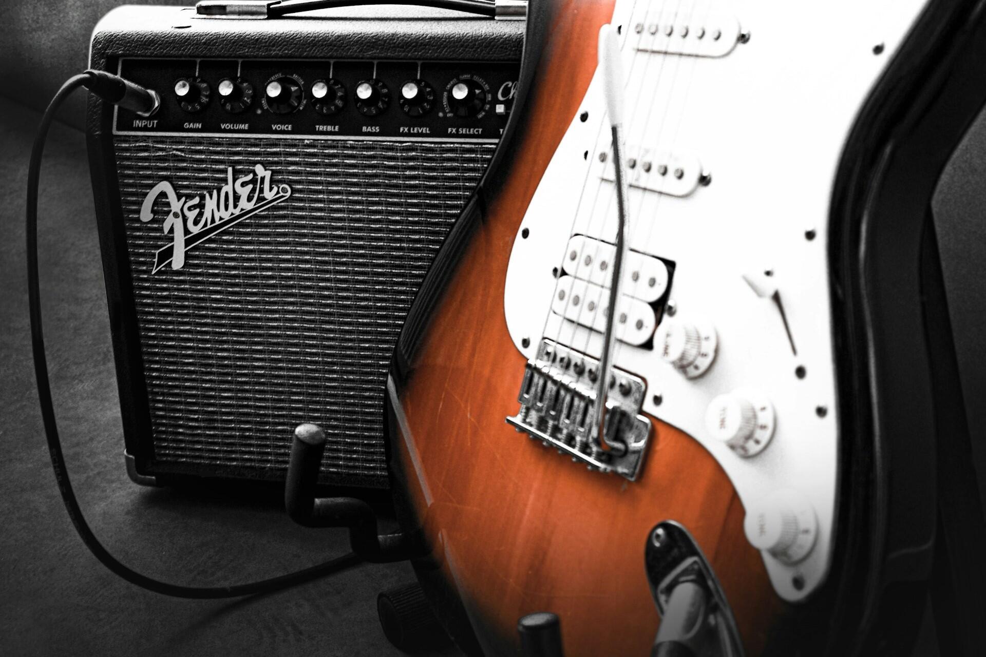 An electric guitar next to an amp.