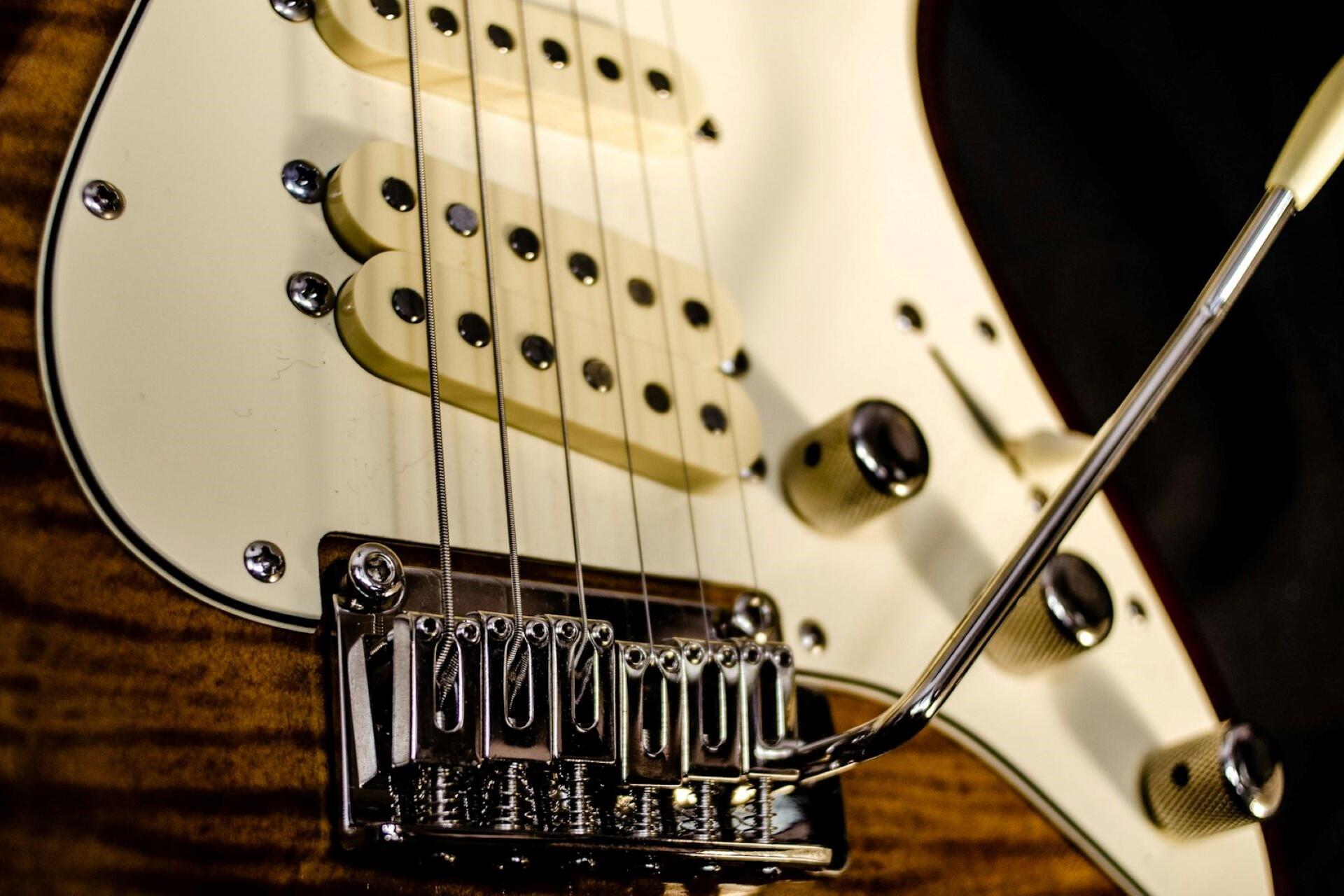 A closeup of an electric guitar bridge.