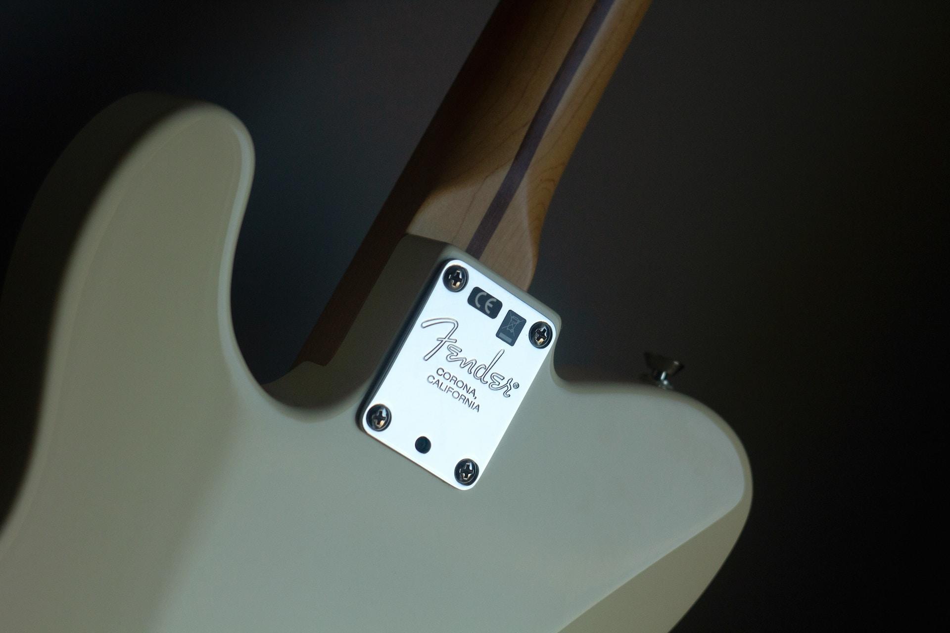A closeup of the back of a Fender electric guitar.