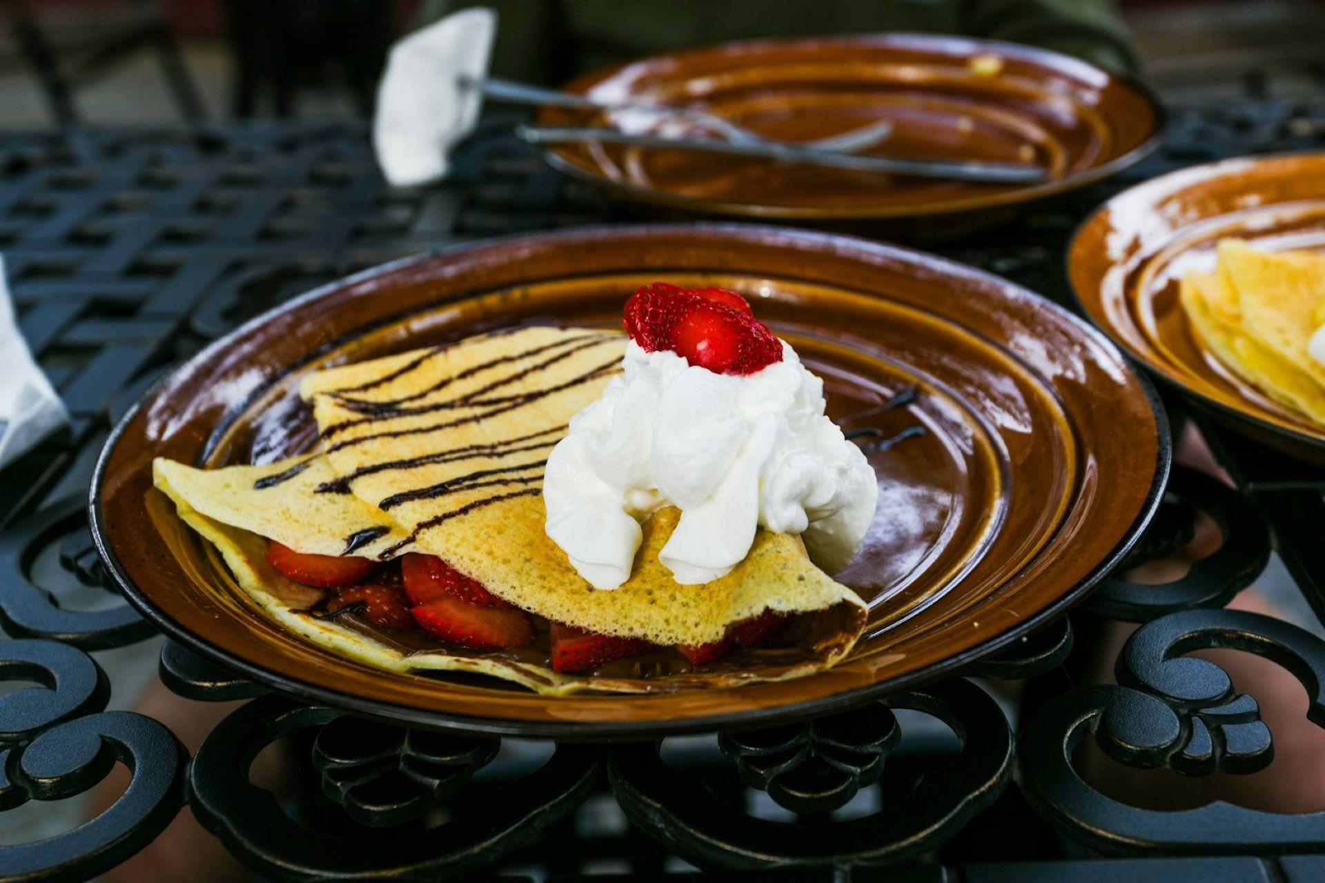 A crepe with strawberries and cream.