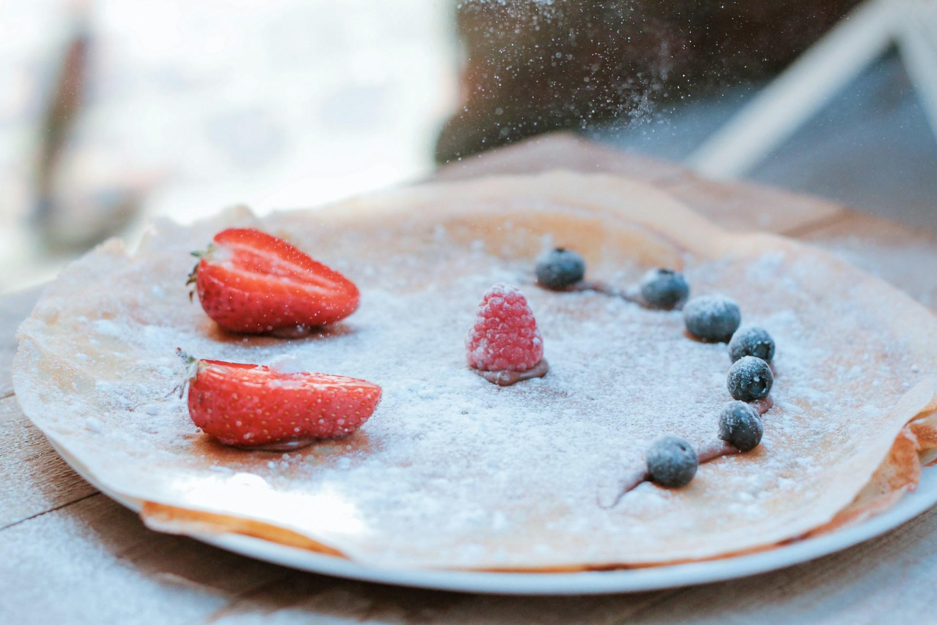 A crepe with a smiley face topping.
