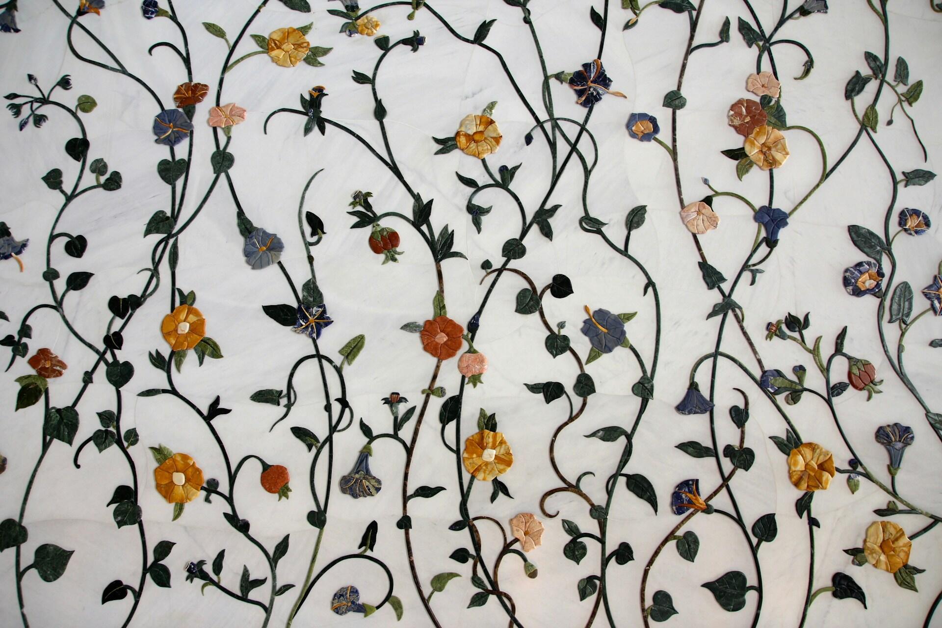 Decorative floral vines and leaves on a pale background