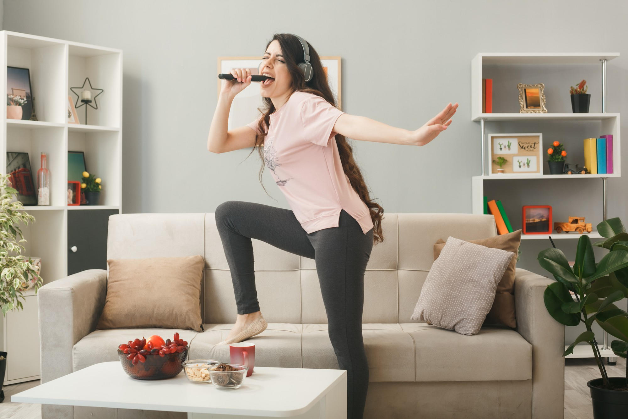 A girl singing at home with a microphone