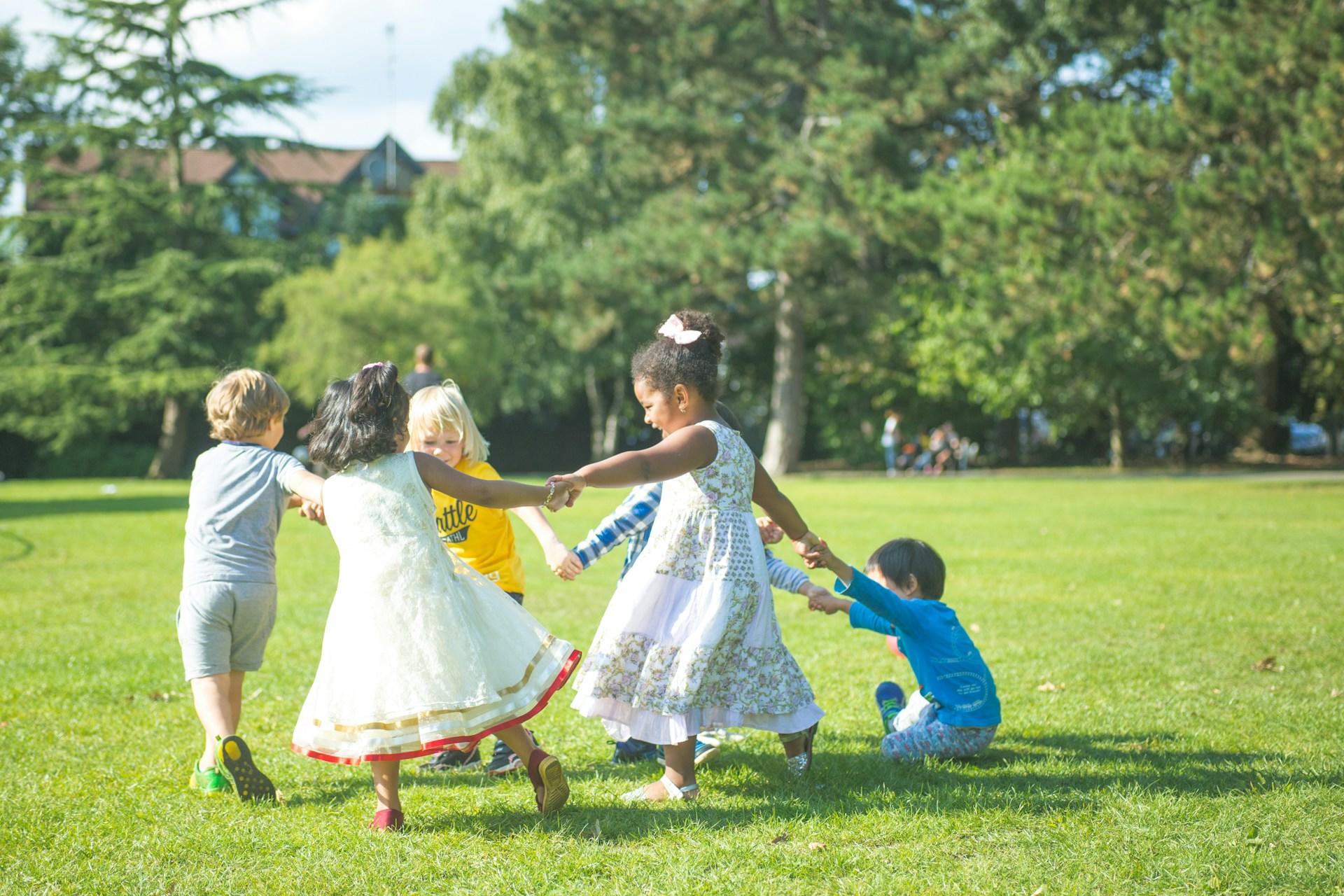 Children playing together in a field or park.