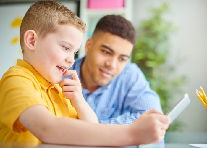 Boy getting help from maths tutor