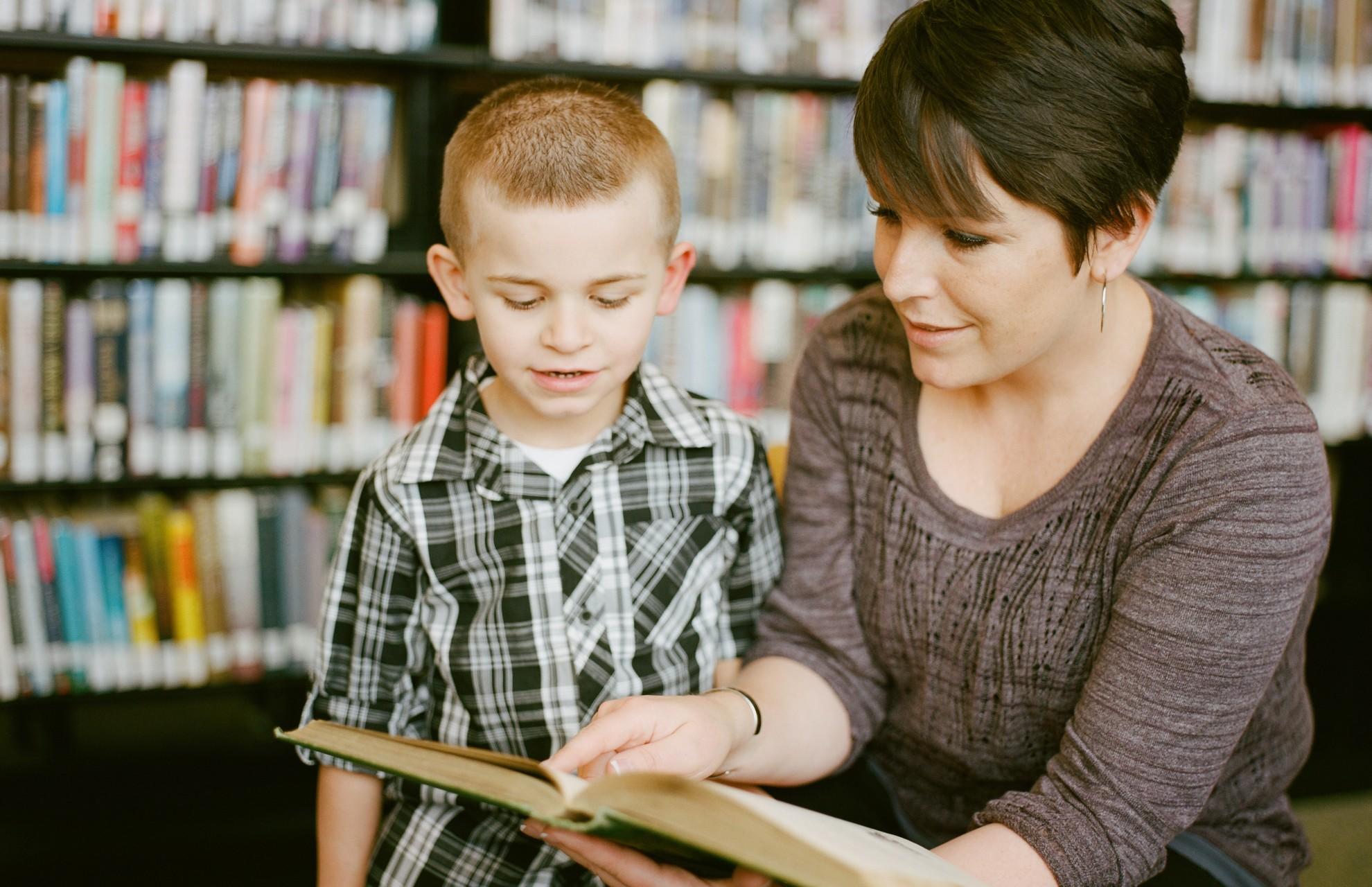 A teacher explaining a book to a child