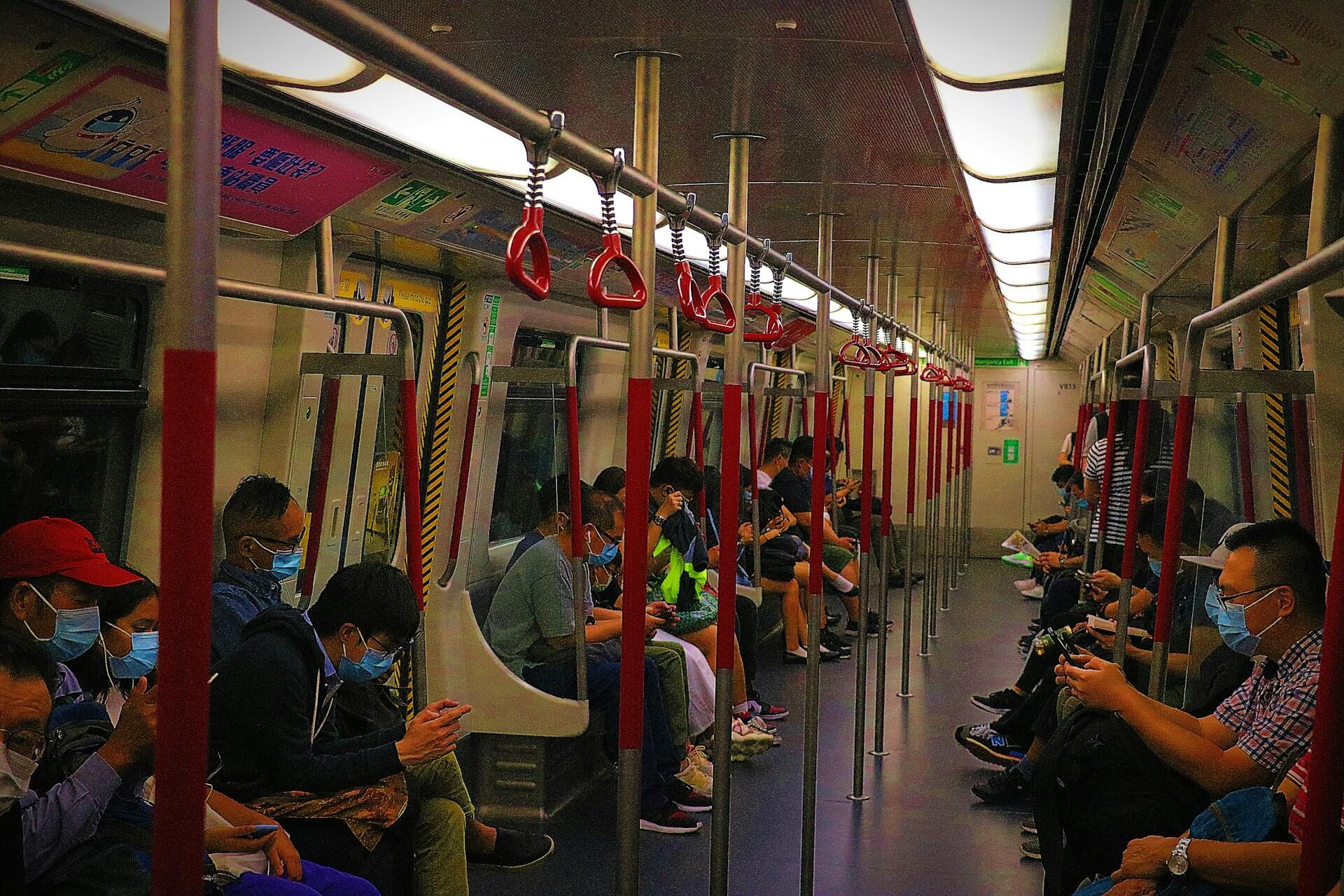 People riding the MTR in Hong Kong.