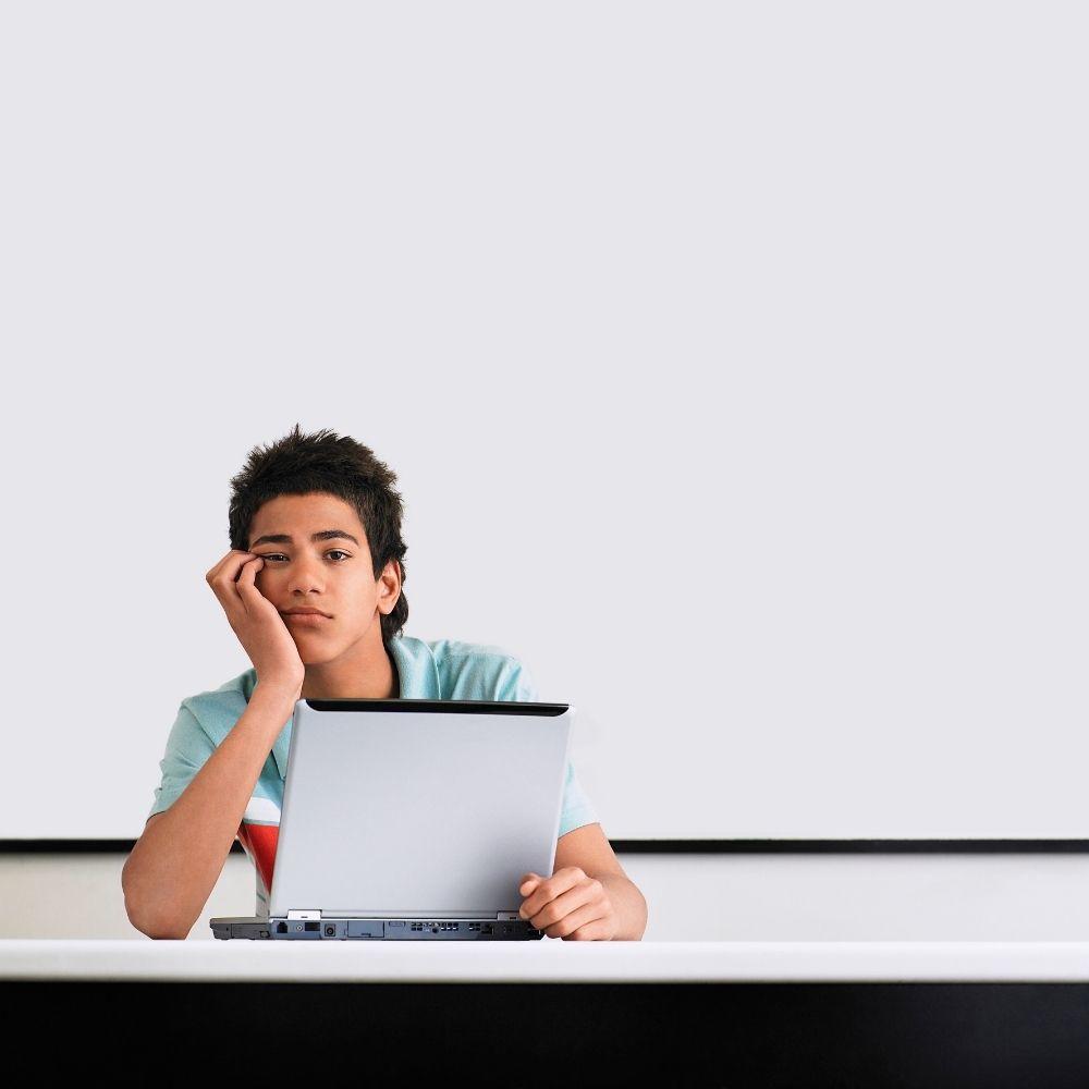 Teenage boy looking bored in maths class