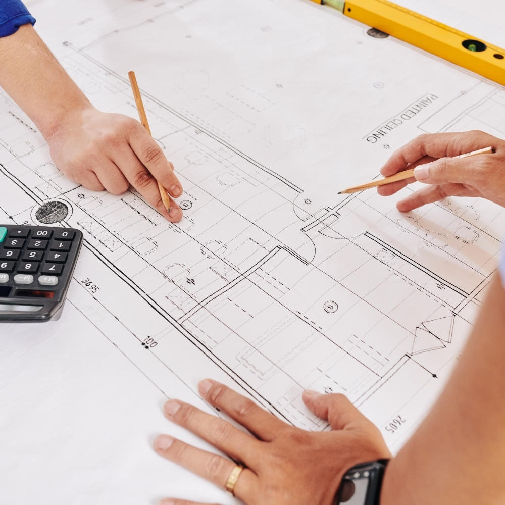 Architects working on a building plan using maths