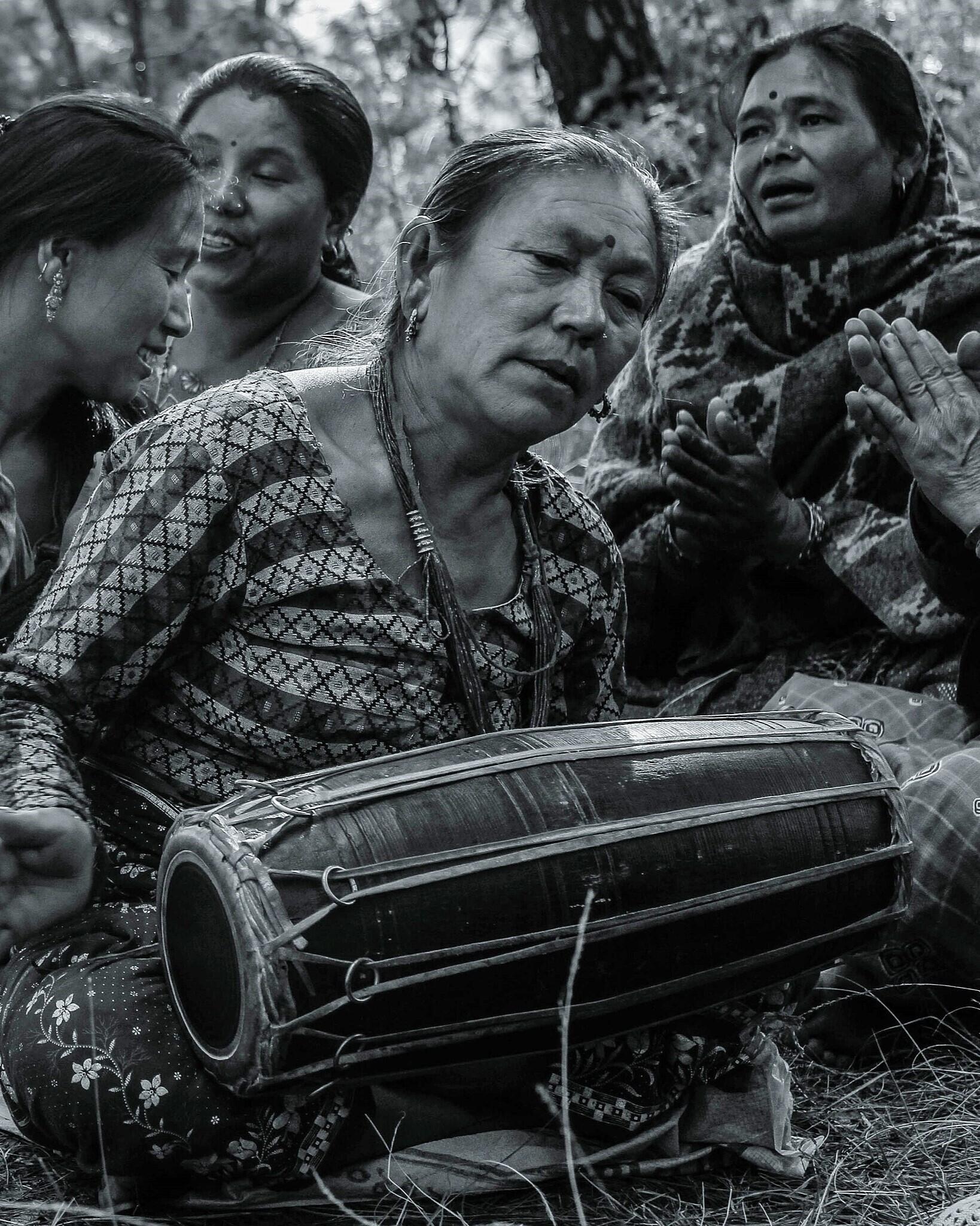 A woman playing a maadal.