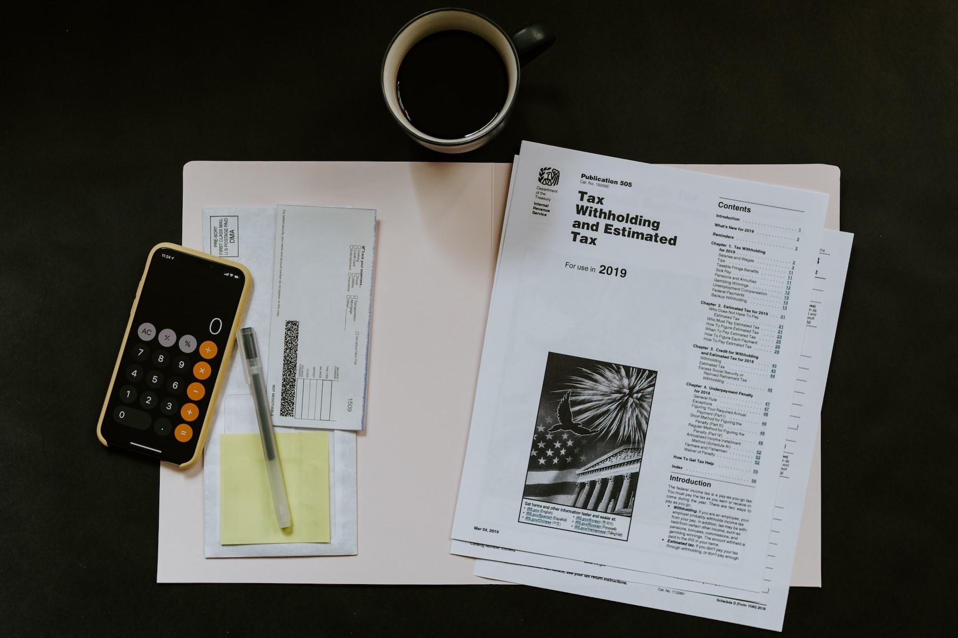 A view of tax guidelines and a cup of coffee.