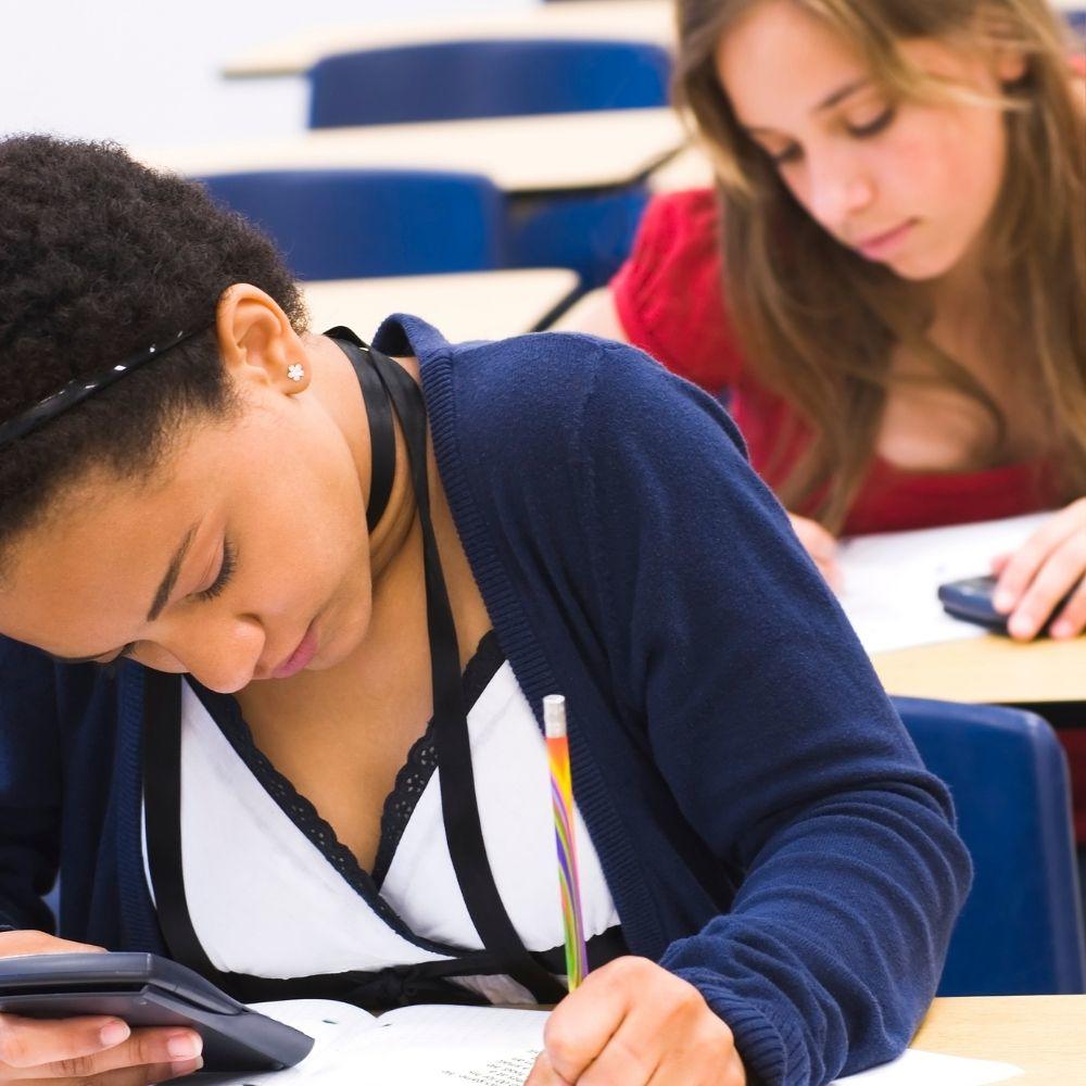 Teenage girls doing maths test