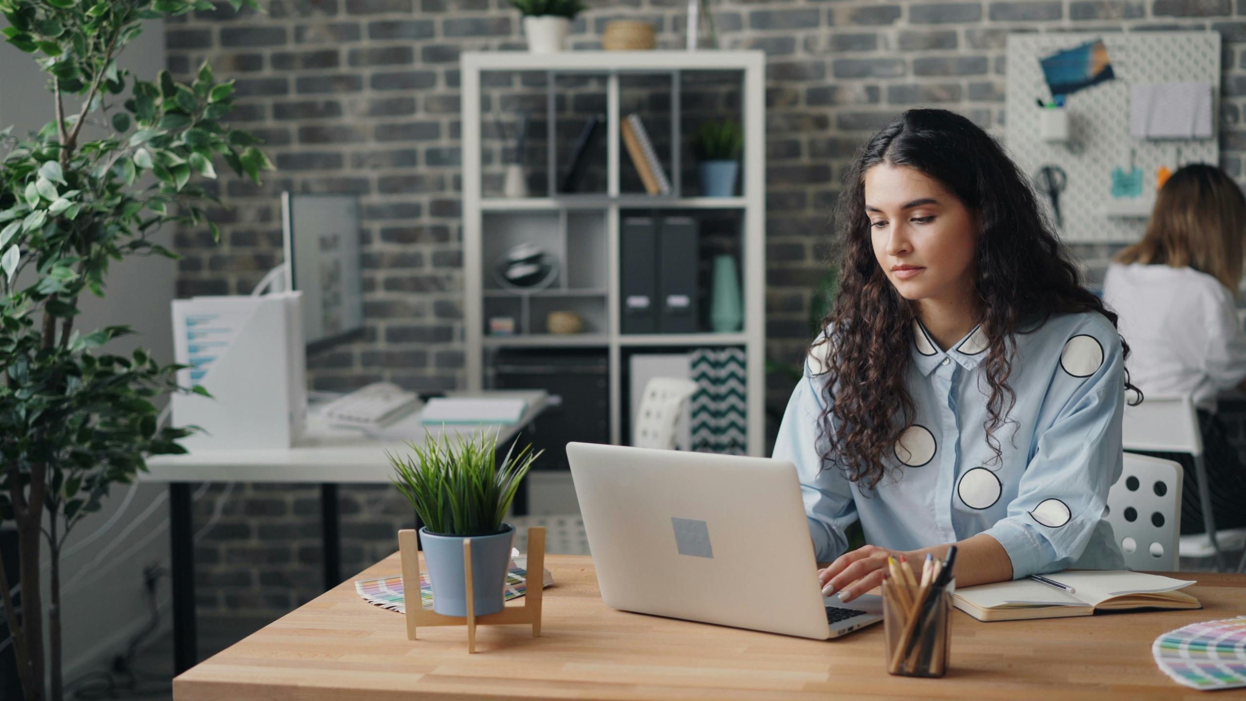 Woman with computer on table desk