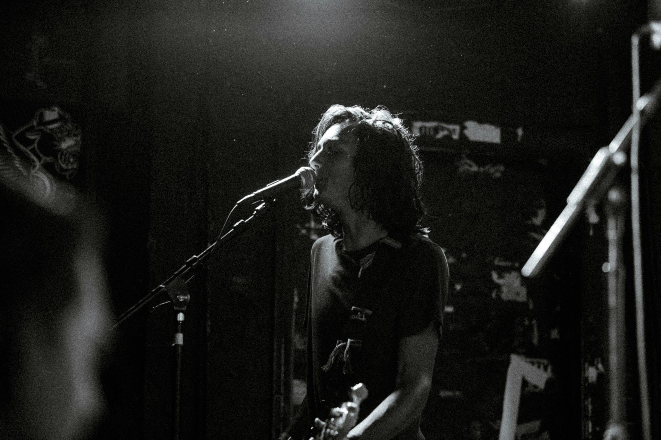 Singer on stage with guitar and mic