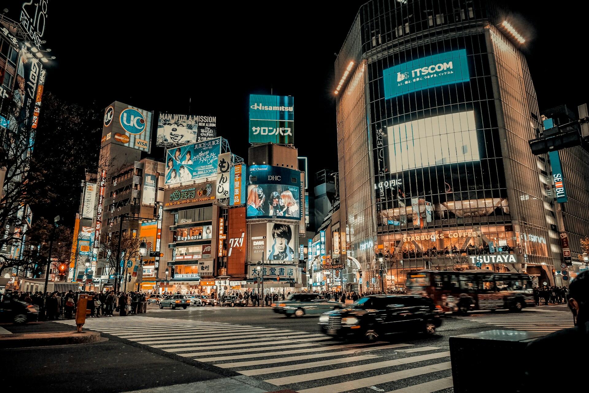 A crosswalk in Japan at night.