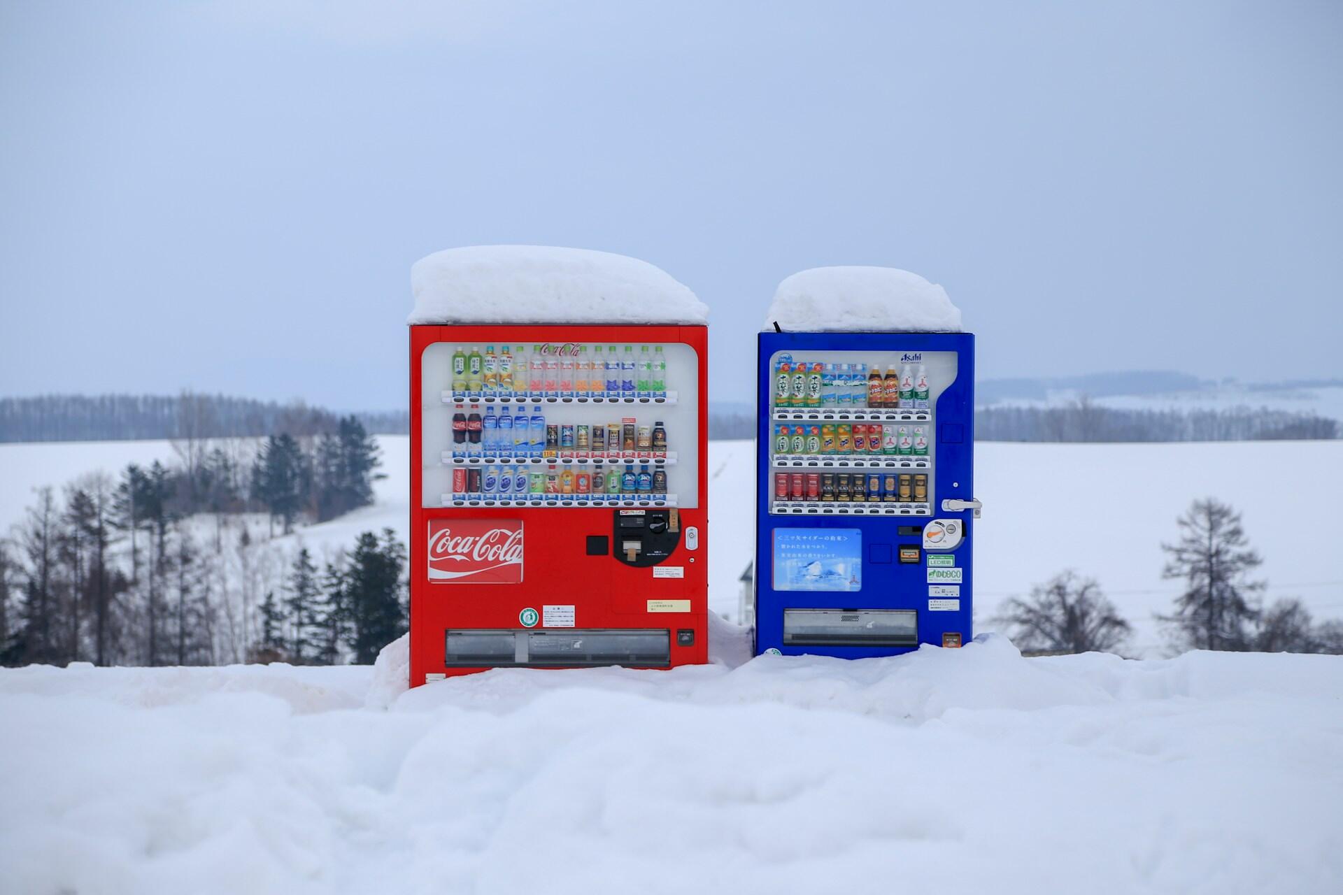 Two vending machines in the snow in Japan.
