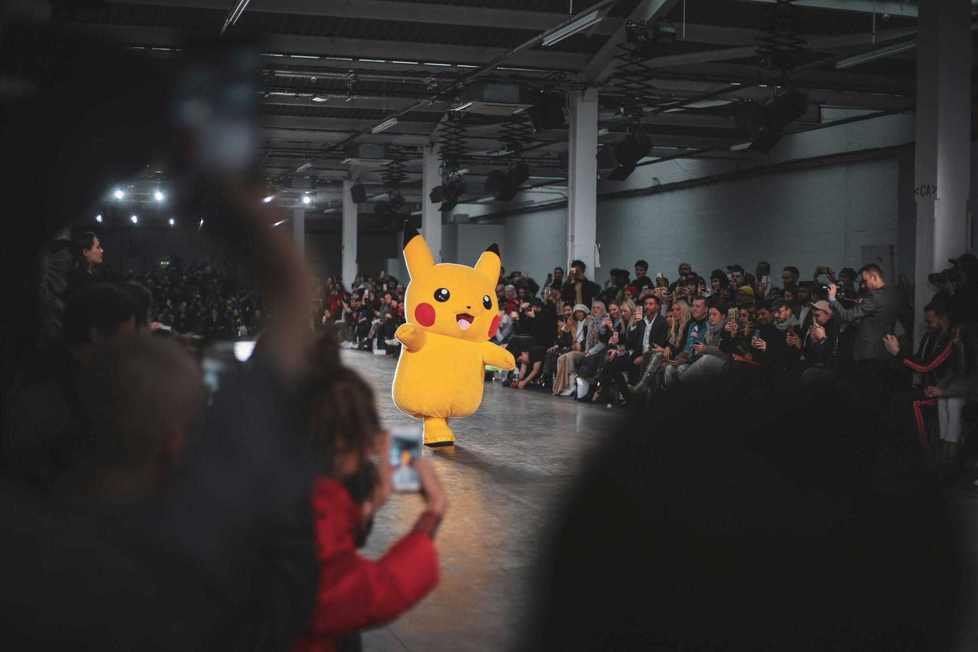 Pikachu on a catwalk in front of spectators.