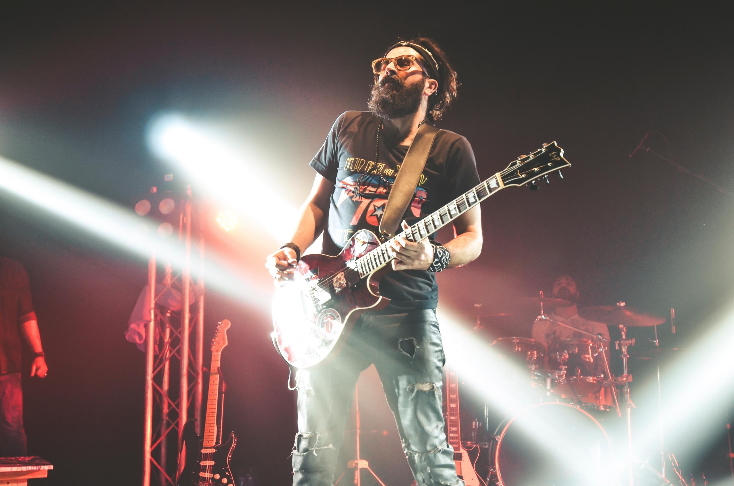 A guitar player can form a band a play with other musicians