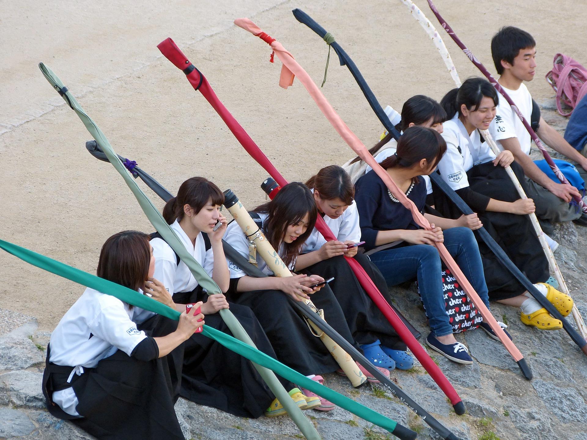 Japanese teenagers sitting after practice