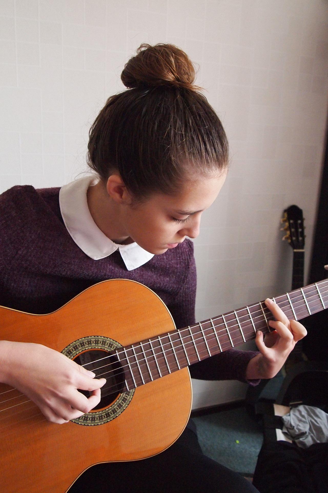 Teen playing spanish guitar to practice NCEA Spanish skills