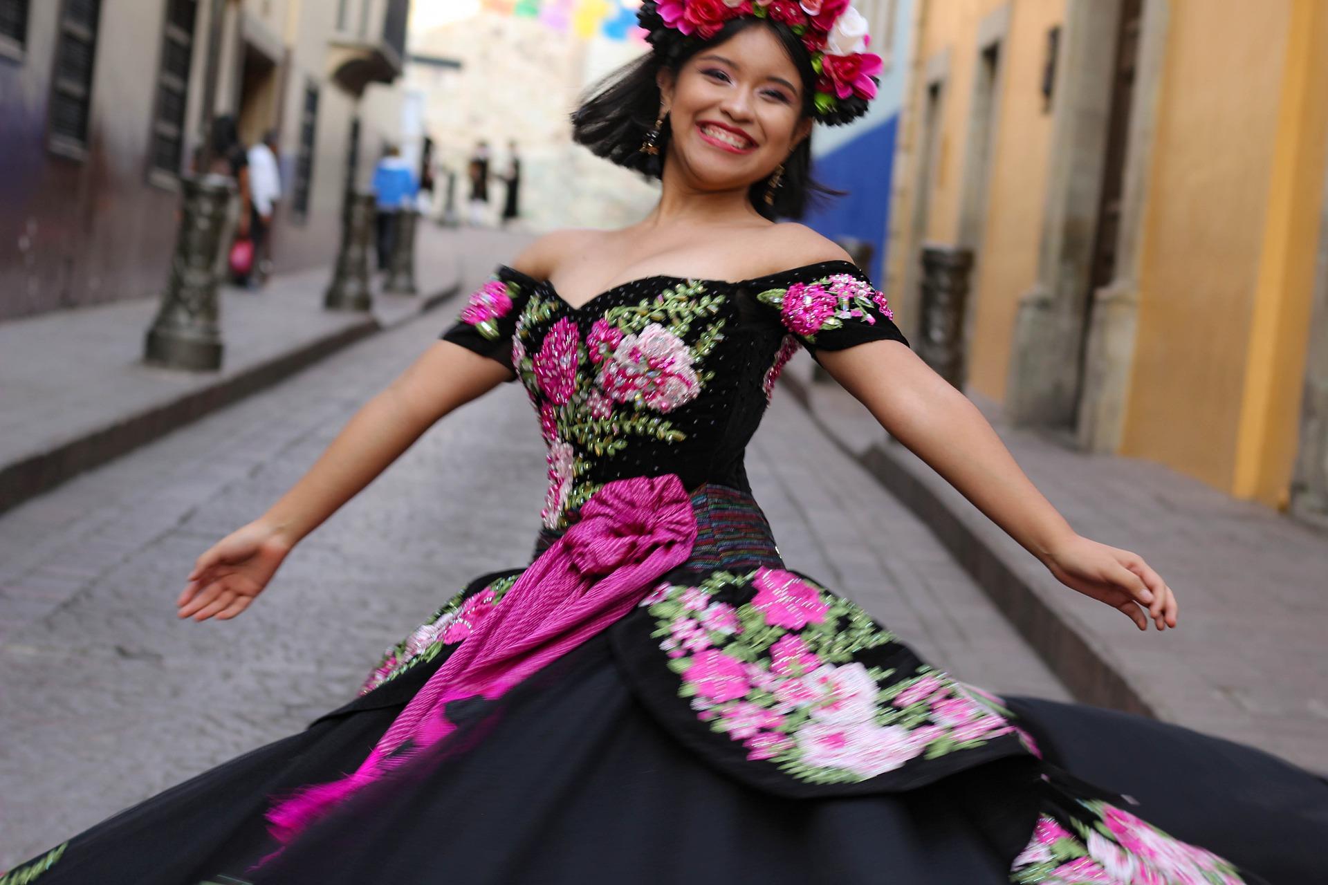 Woman dancing while wearing Traditional Mexican costume