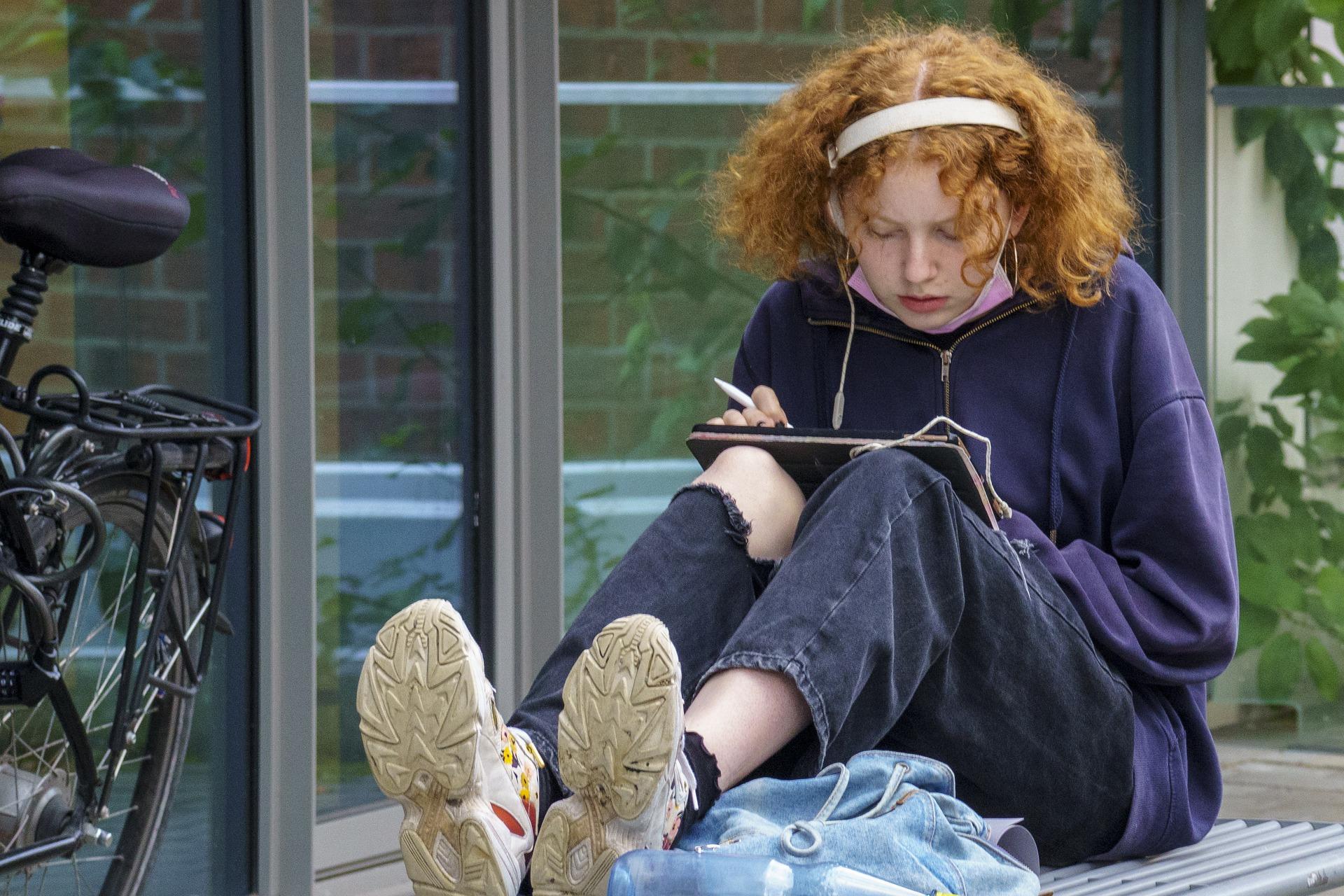 Kiwi teen listening to NCEA Spanish audio exams