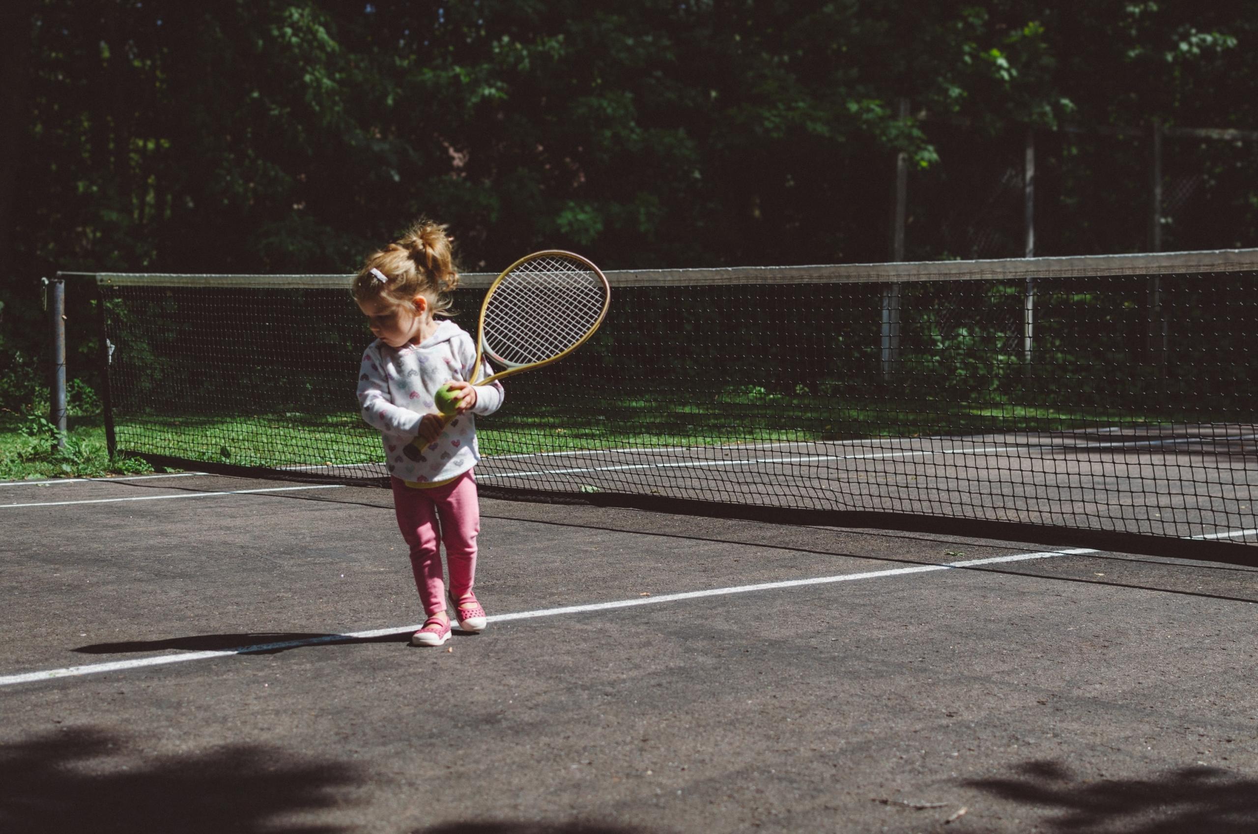 Child playing tennis