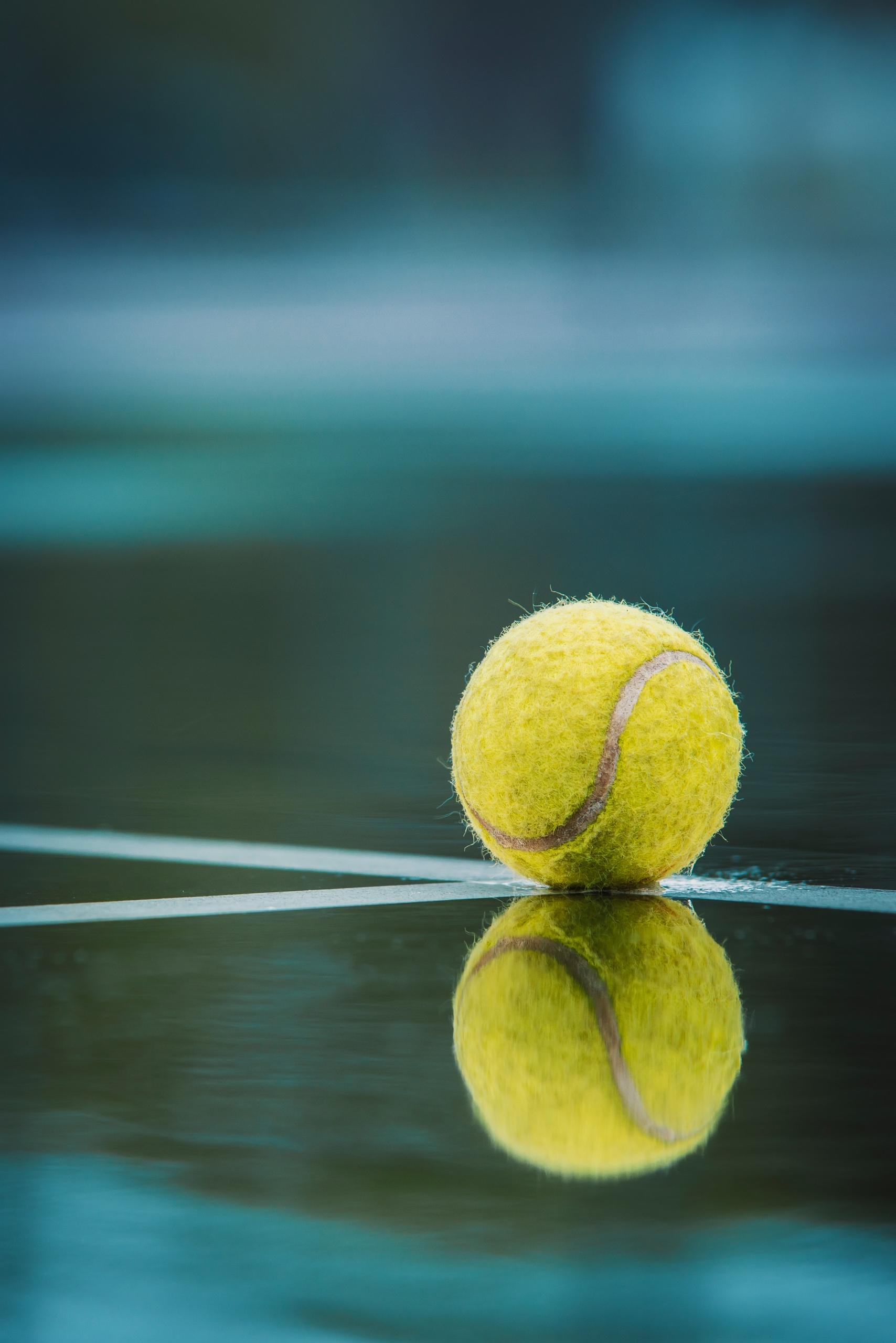 Tennis ball on tennis court line