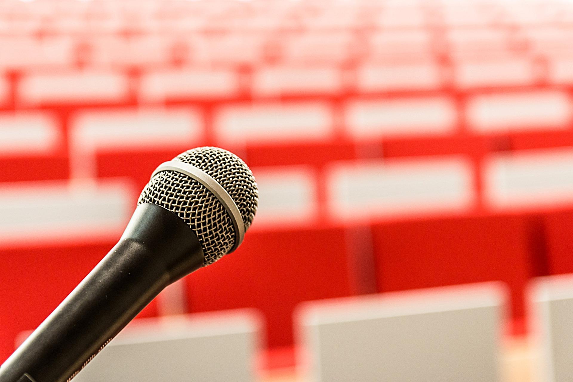 Microphone with empty seats in background