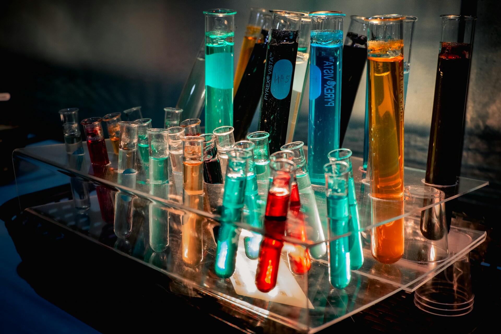 Laboratory test tubes containing colourful chemical solutions