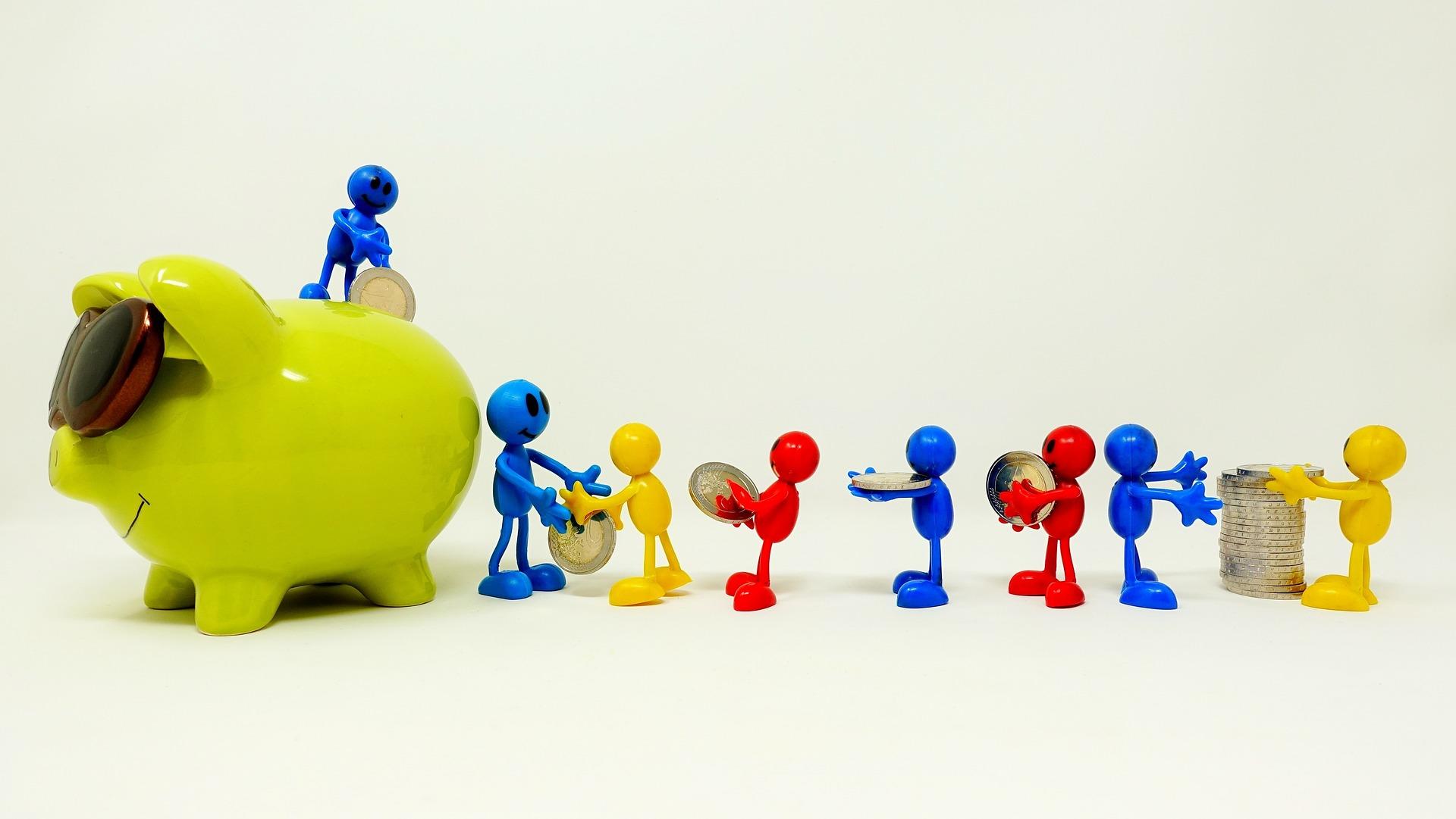 Piggy bank with plastic figures carrying coins