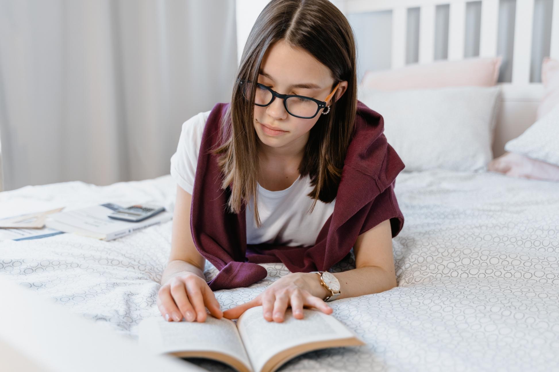 A girl studying python in bed.