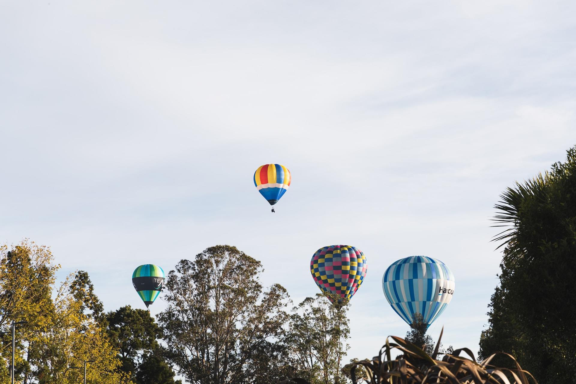Hot air balloons floating over Lake Hamilton, Hamilton, New Zealand.