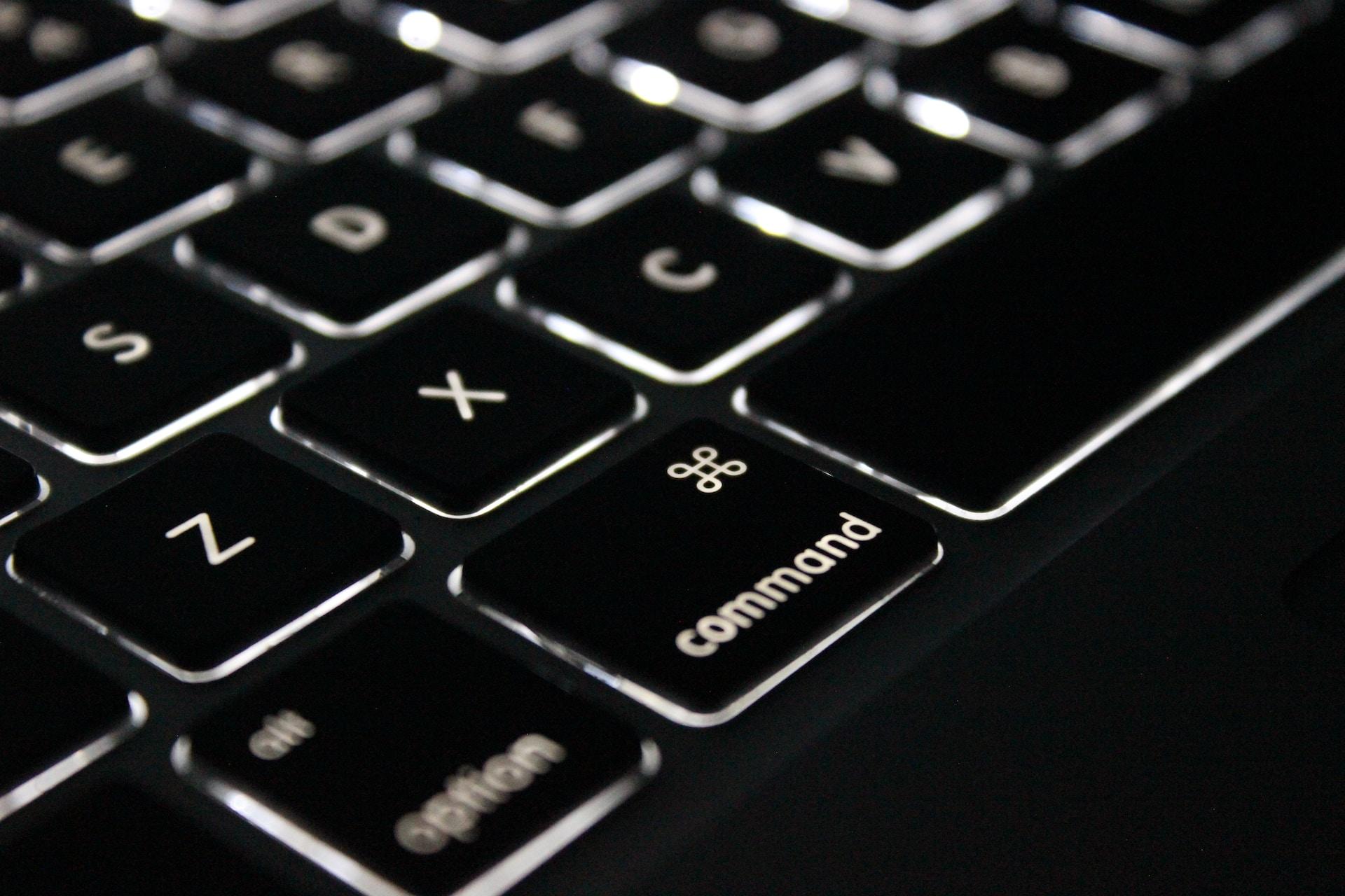 A closeup of a black Mac keyboard.