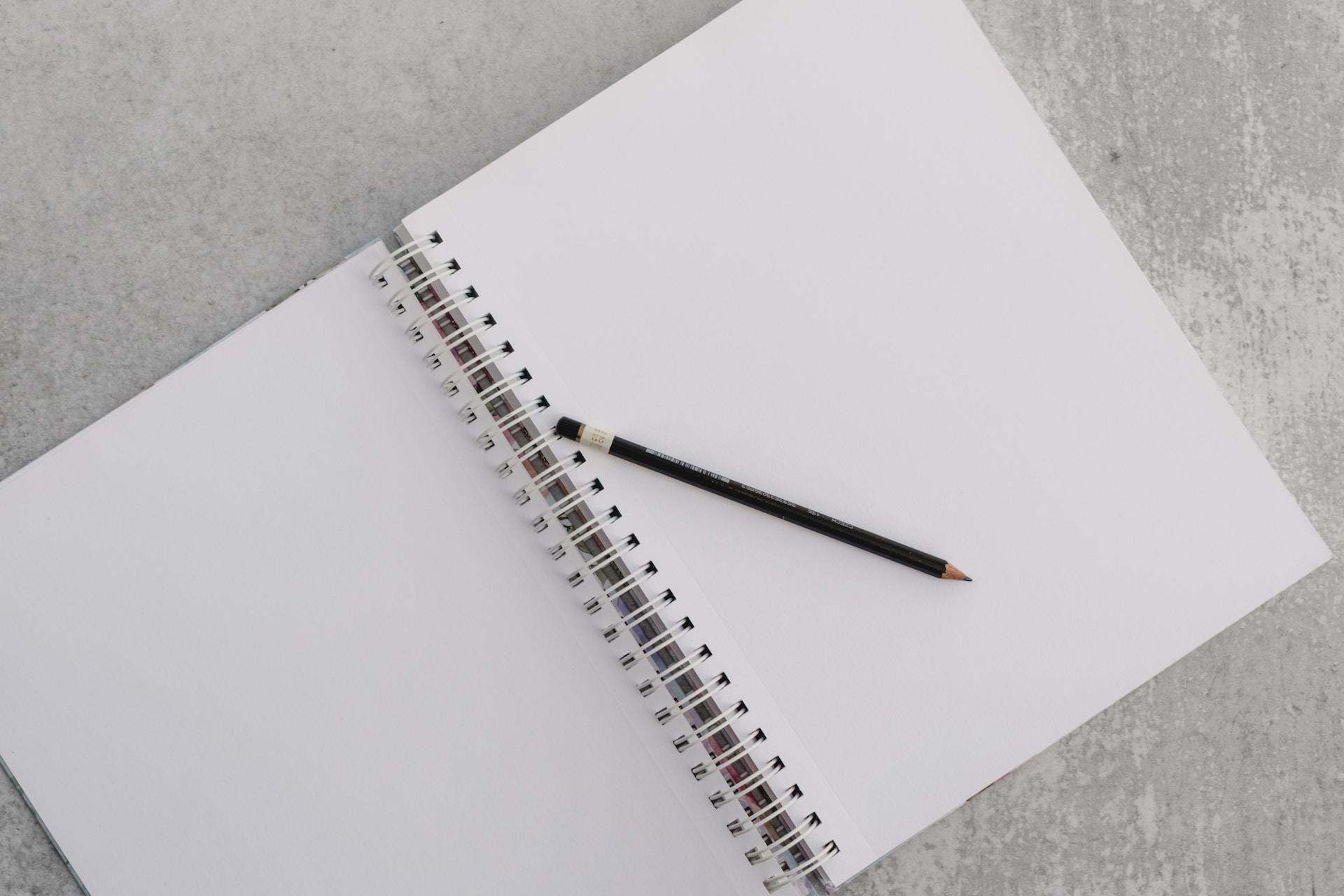 A blank sketchbook with a pencil.