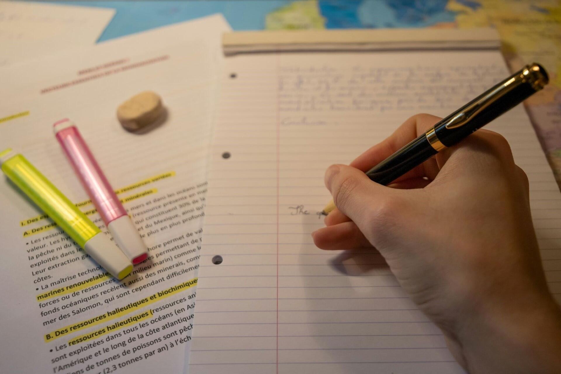 A person writing some notes or doing homework.