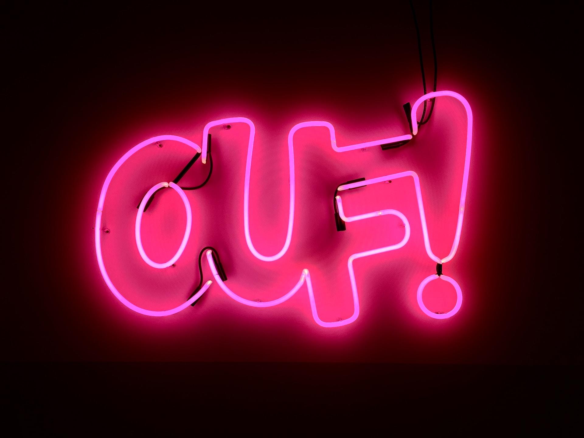 A pink neon sign that declares: Ouf!