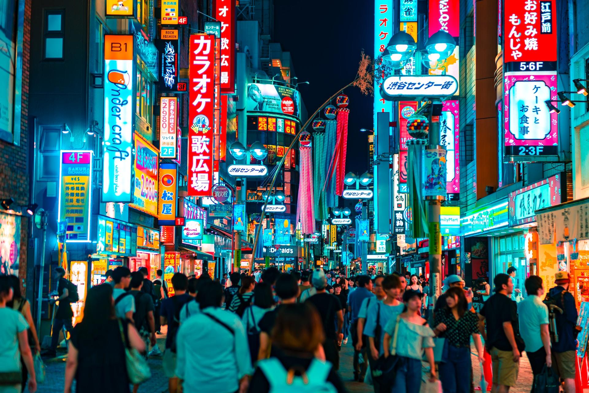 People shopping in Shibuya, Japan, at night.