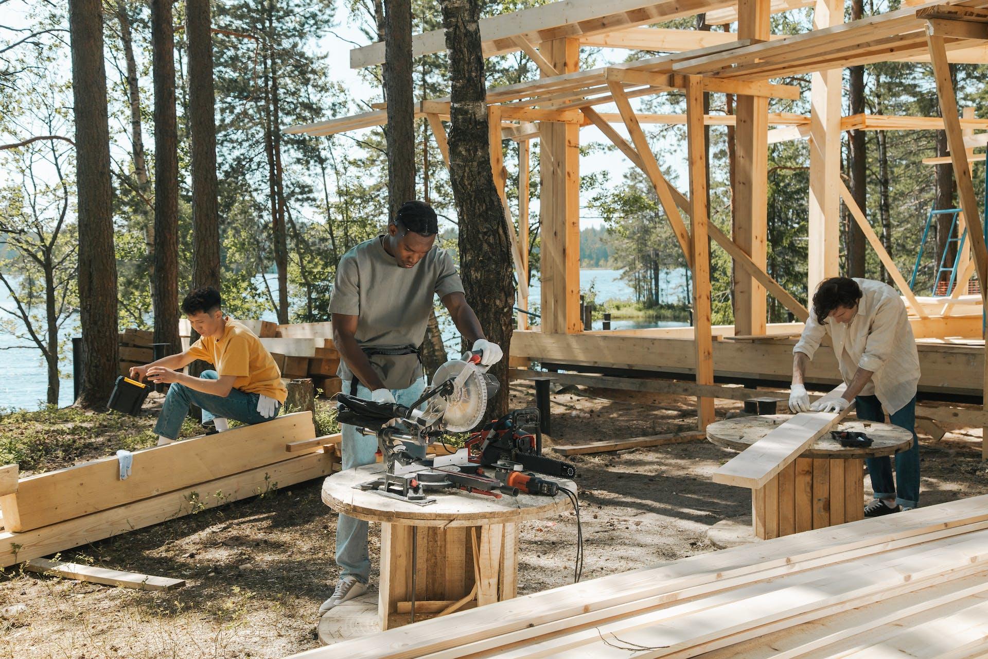 A group of carpenters using power tools and building a house