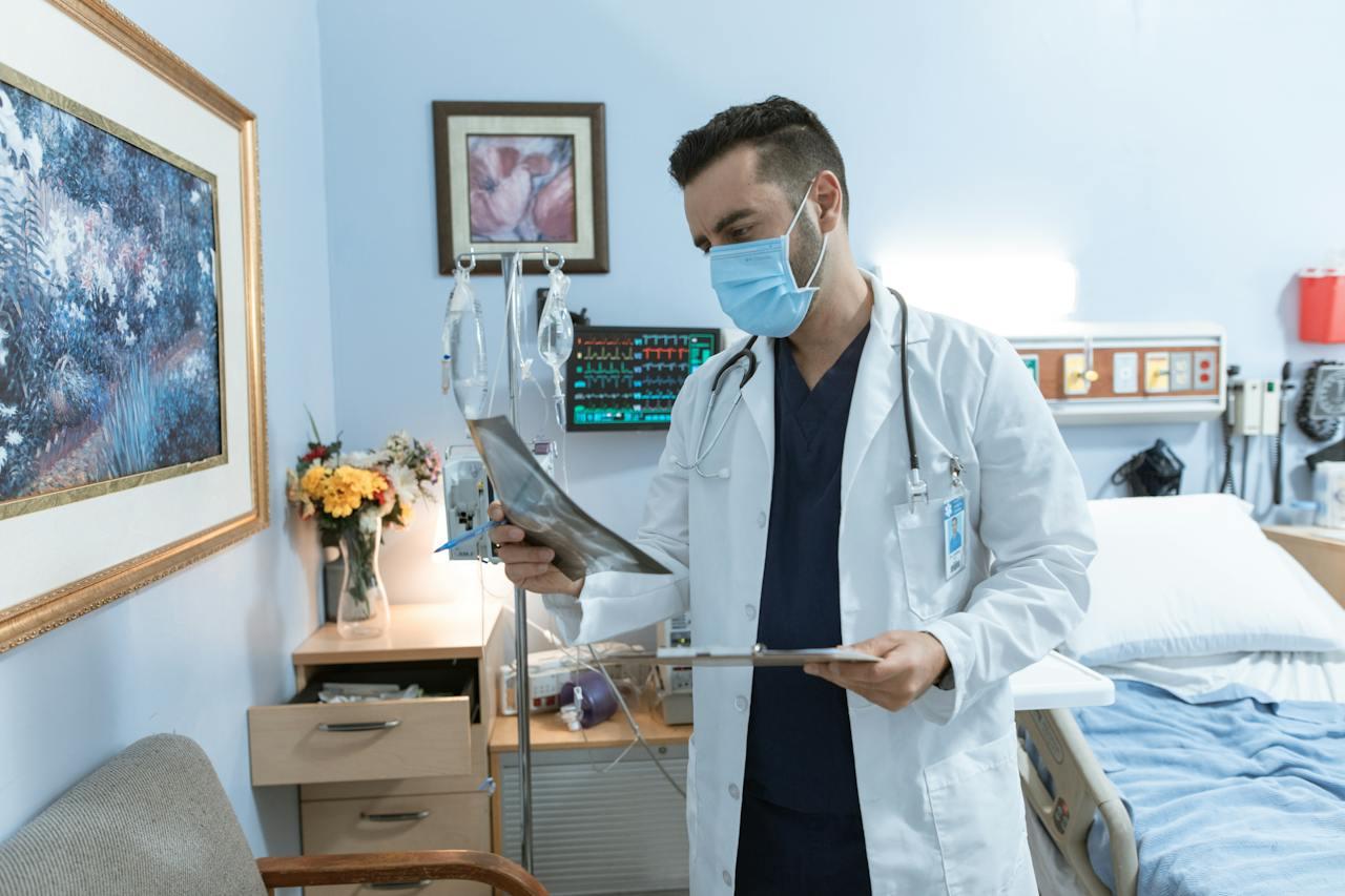 A doctor checking a chart in a patient's room