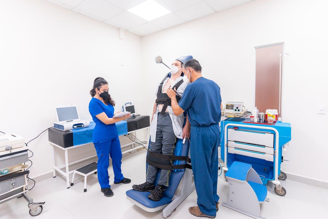 Doctors doing a faint test with a patient