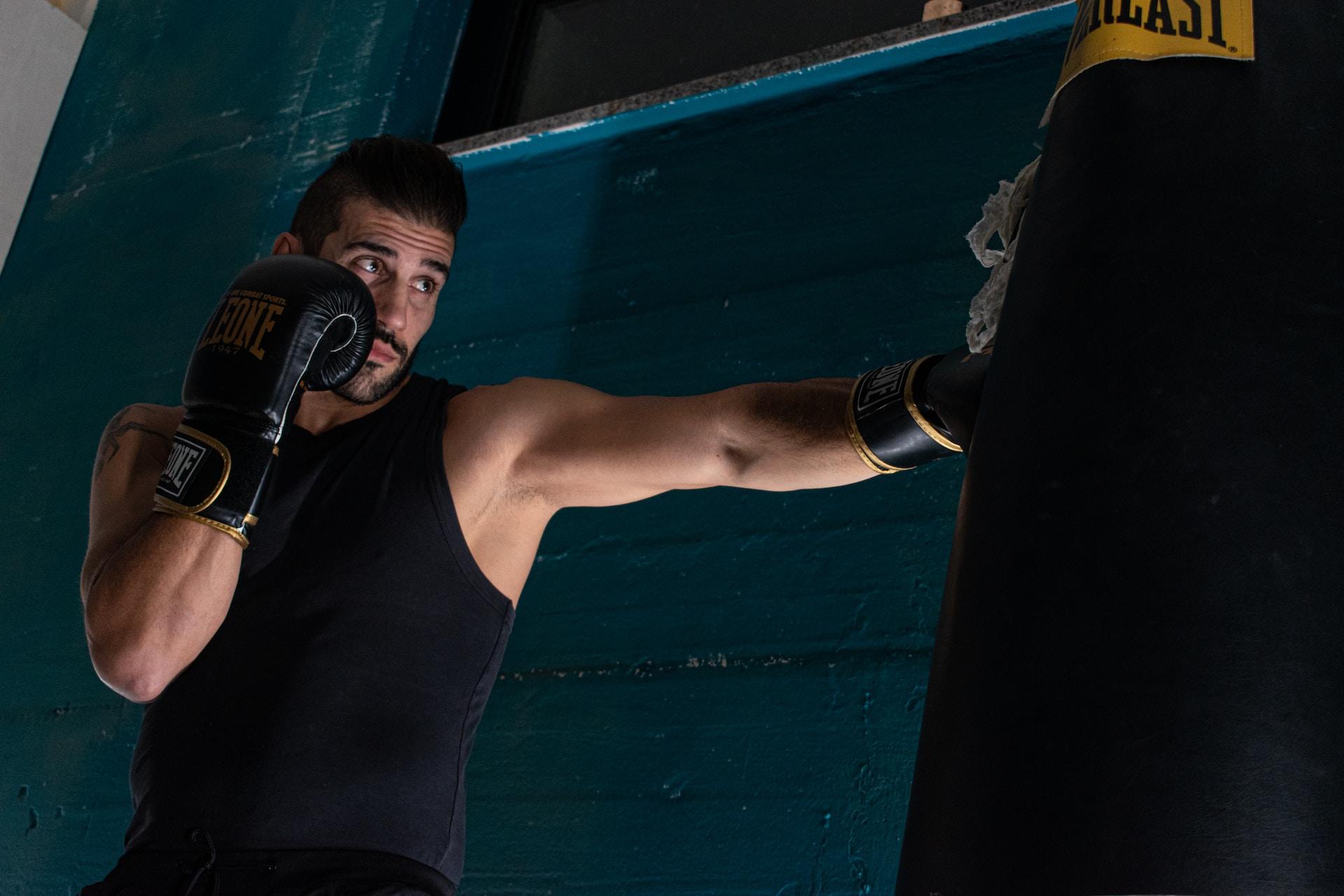 A man exercising with a punching bag.