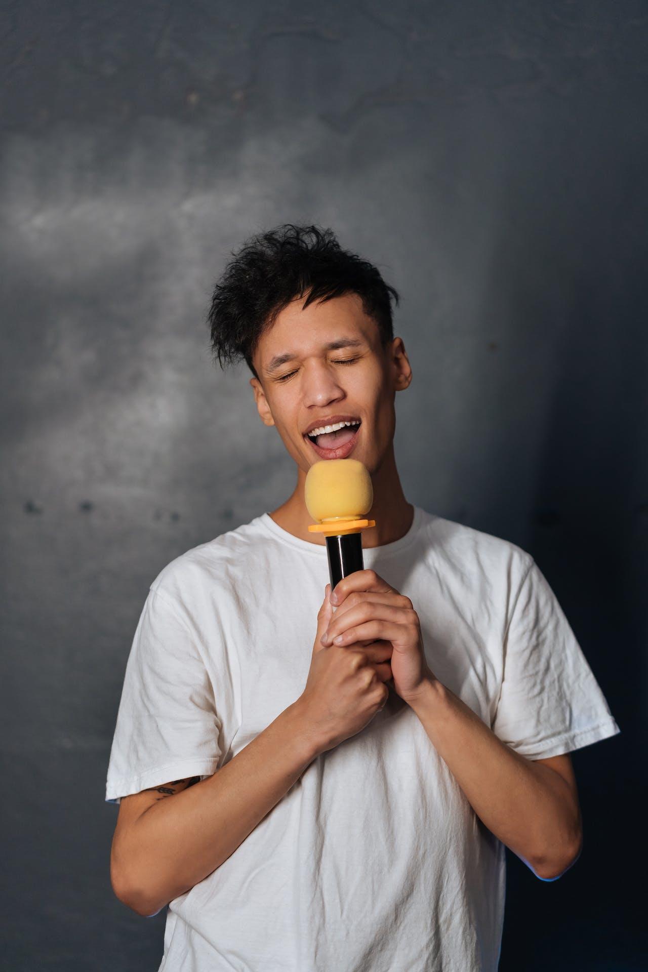A man singing into a toy microphone